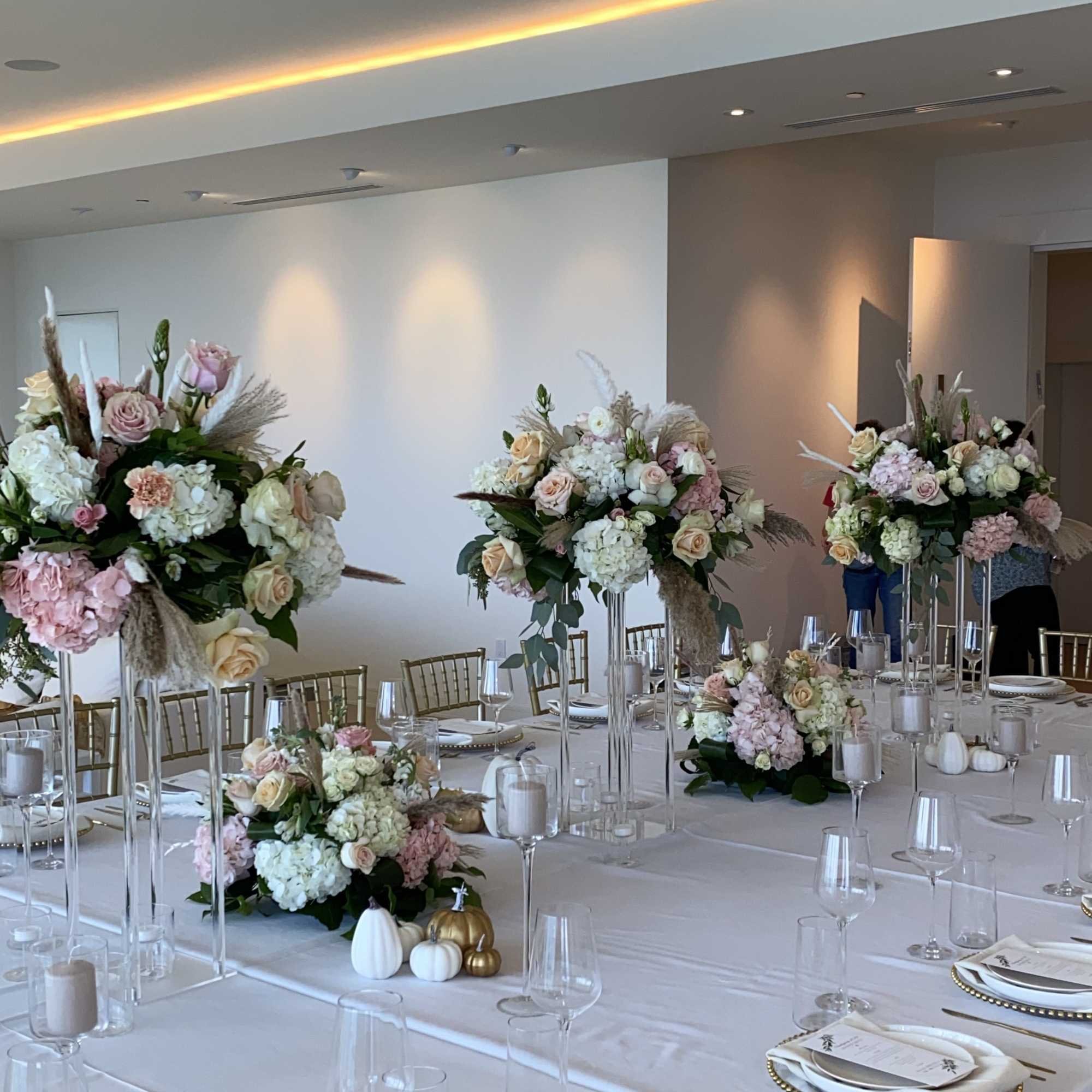 Pastel floral centerpieces on a decorated banquet table