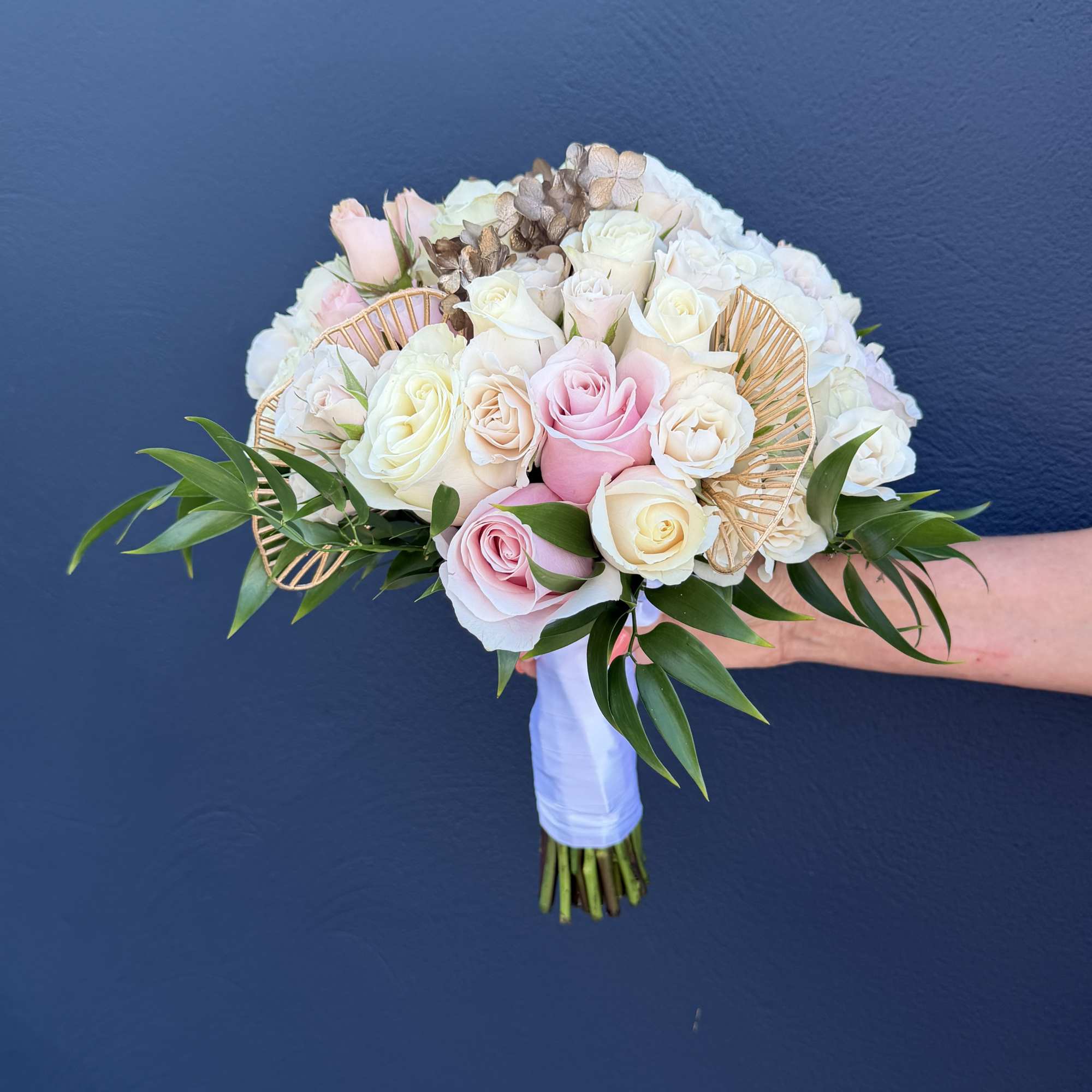 Wedding bouquet of pink and white roses with gold fan accents, photo 3 of 3