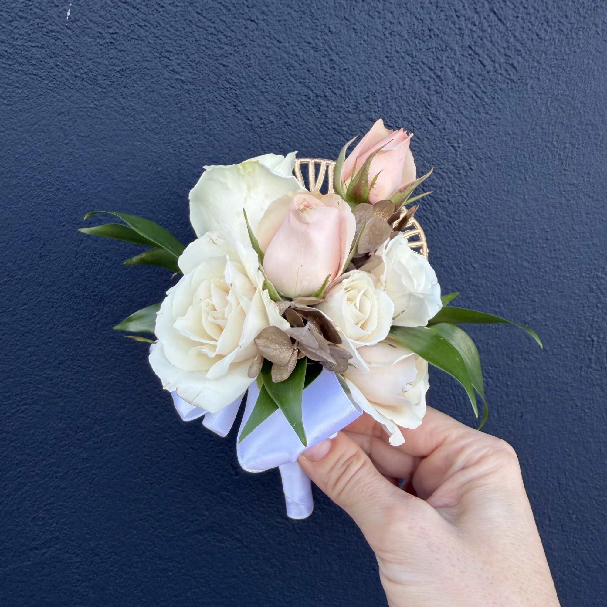 Small bridal bouquet of white and blush roses with ribbon
