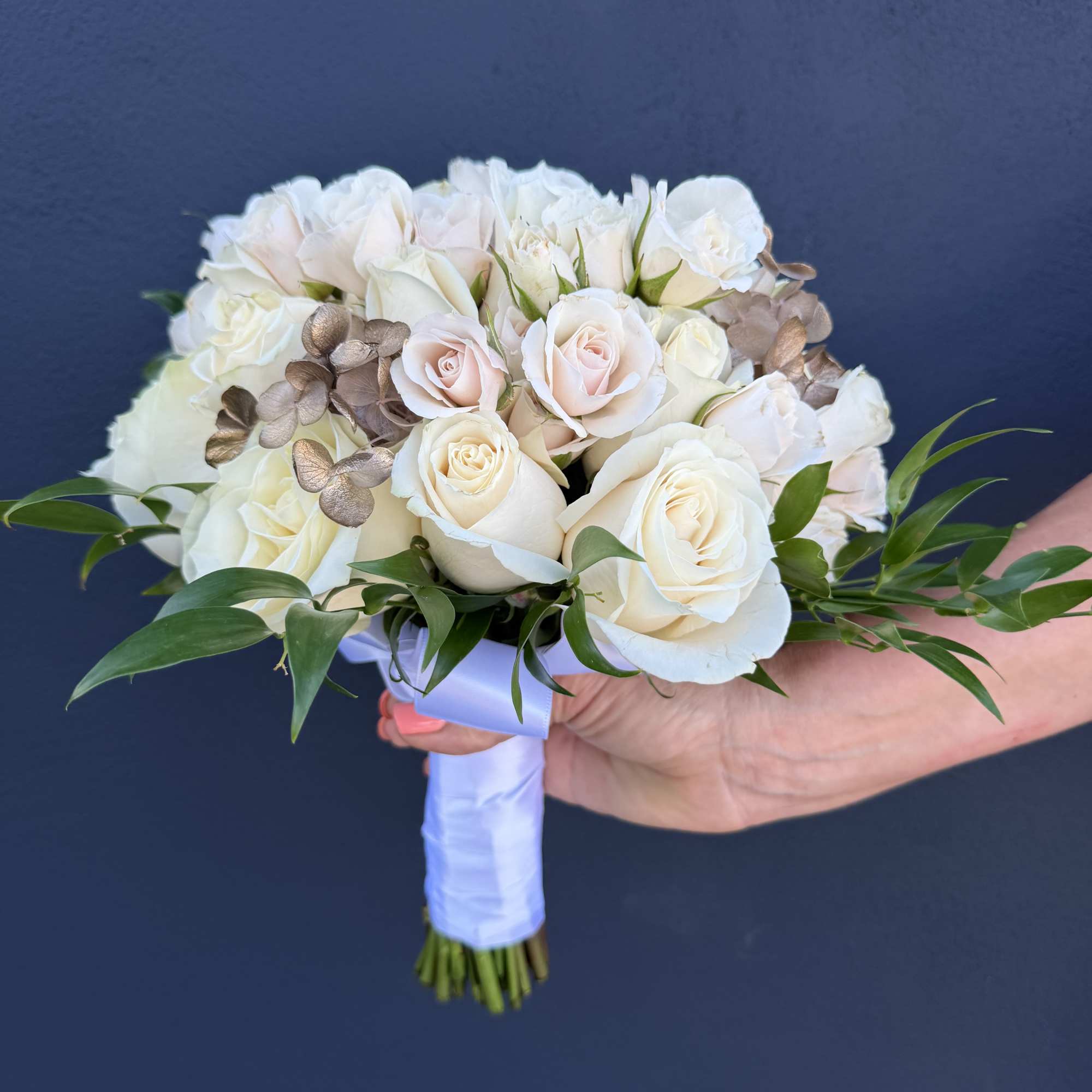 White and blush rose bridal bouquet with greenery and ribbon wrap