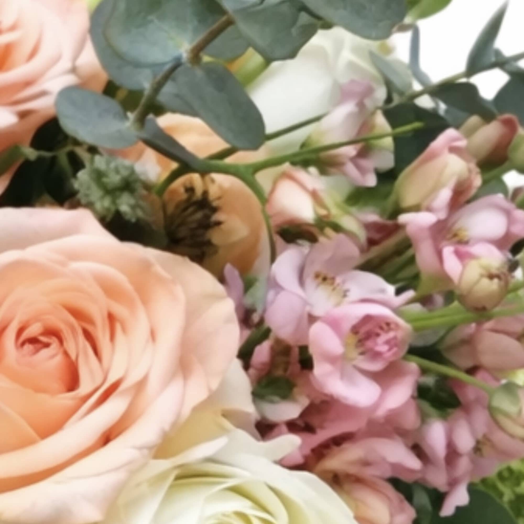 Bouquet of peach and white roses with pink blossoms