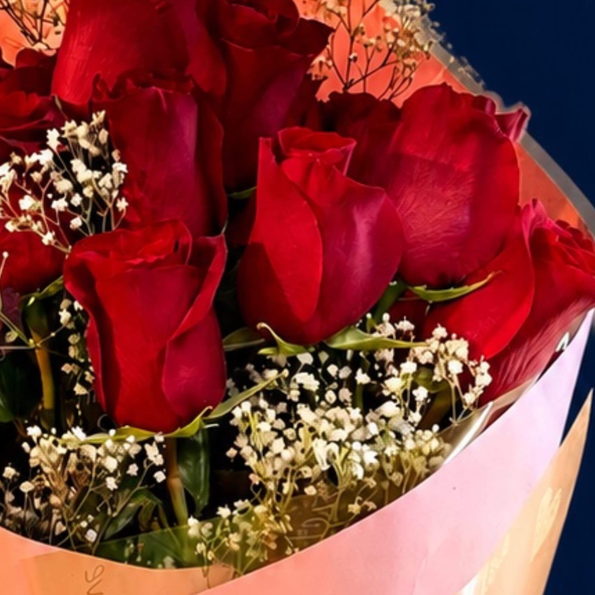 A dense cluster of 12 deep red roses framed by delicate white, photo 2 of 2