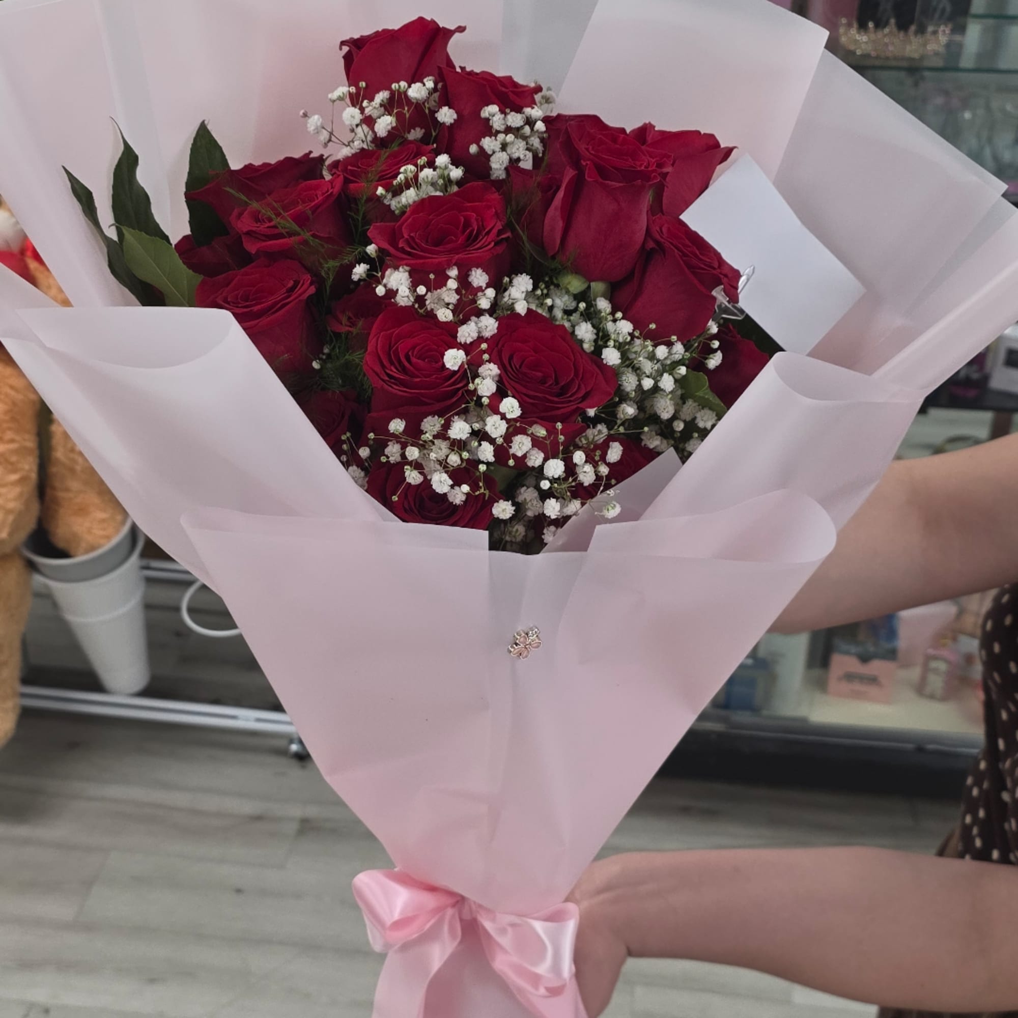Bouquet of red roses with white baby's breath in pink wrapping, photo 3 of 3