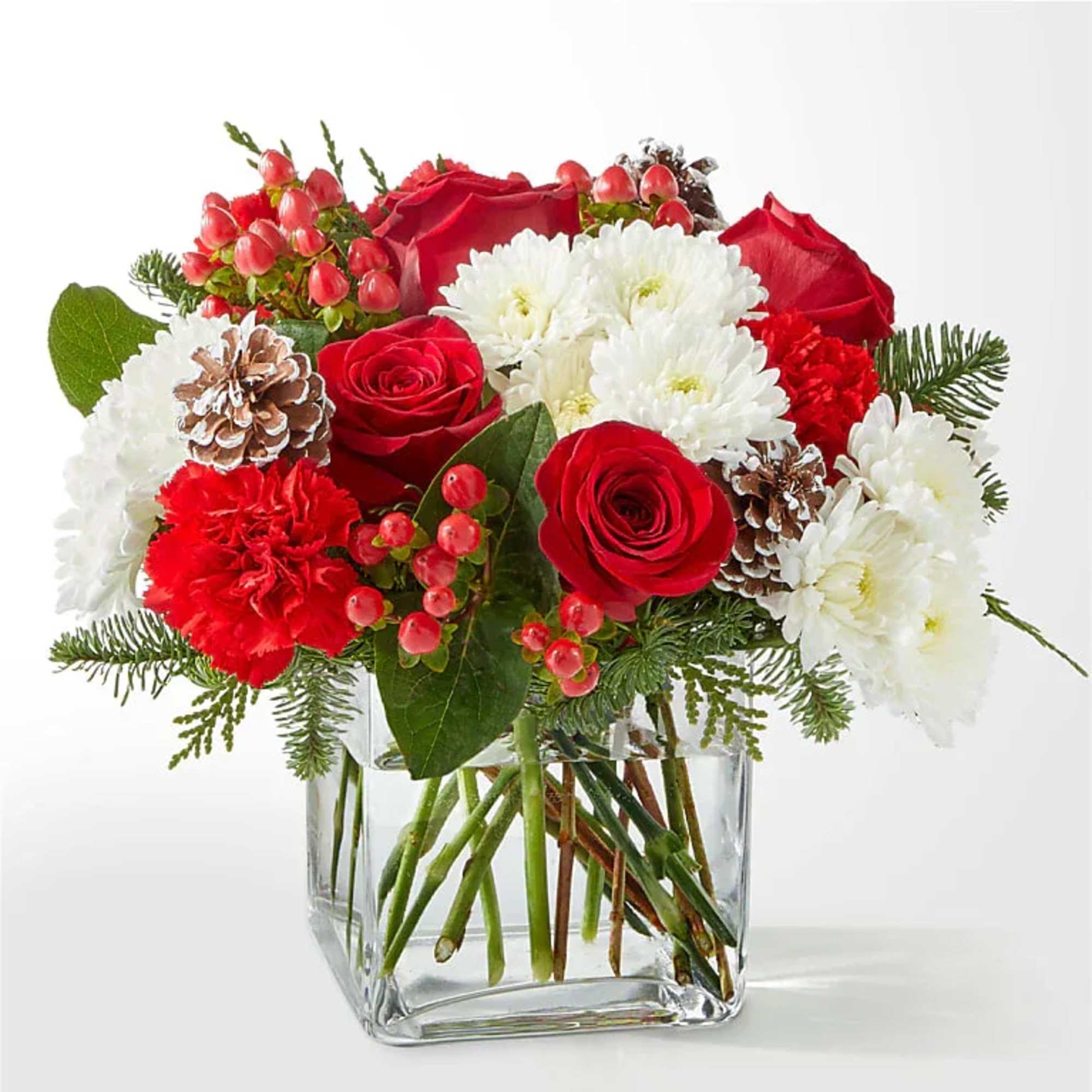 Red roses and white chrysanthemums in a clear glass vase