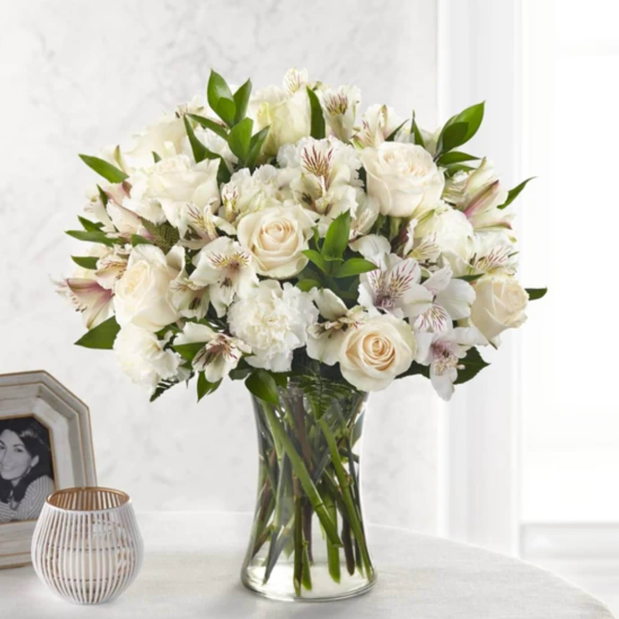 White roses and alstroemeria in a clear glass vase