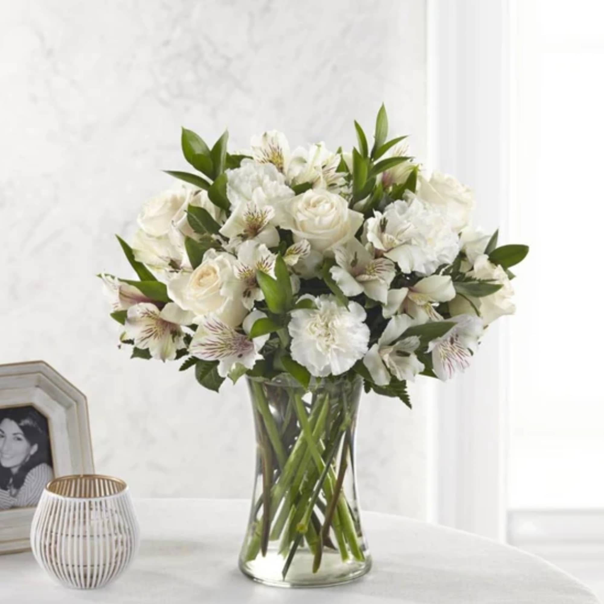 White floral bouquet in a clear glass vase