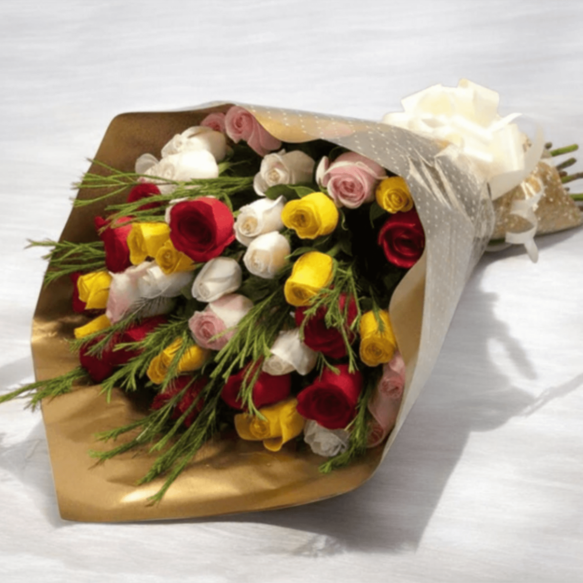 A vibrant mix of red, yellow, white and blush-pink roses creates an