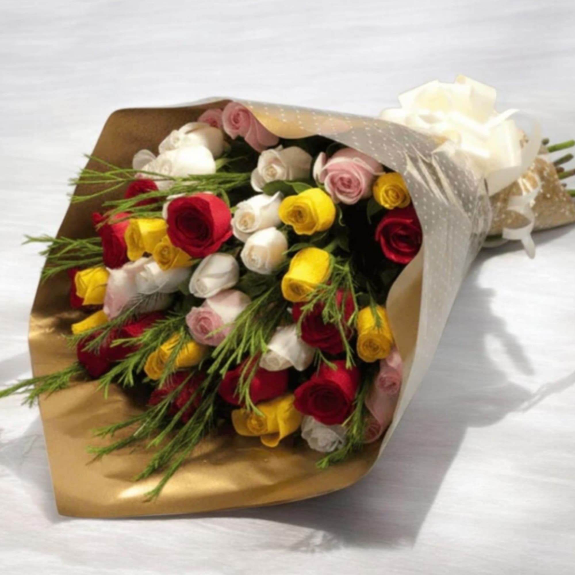 A vibrant mix of red, yellow, white and blush-pink roses creates an