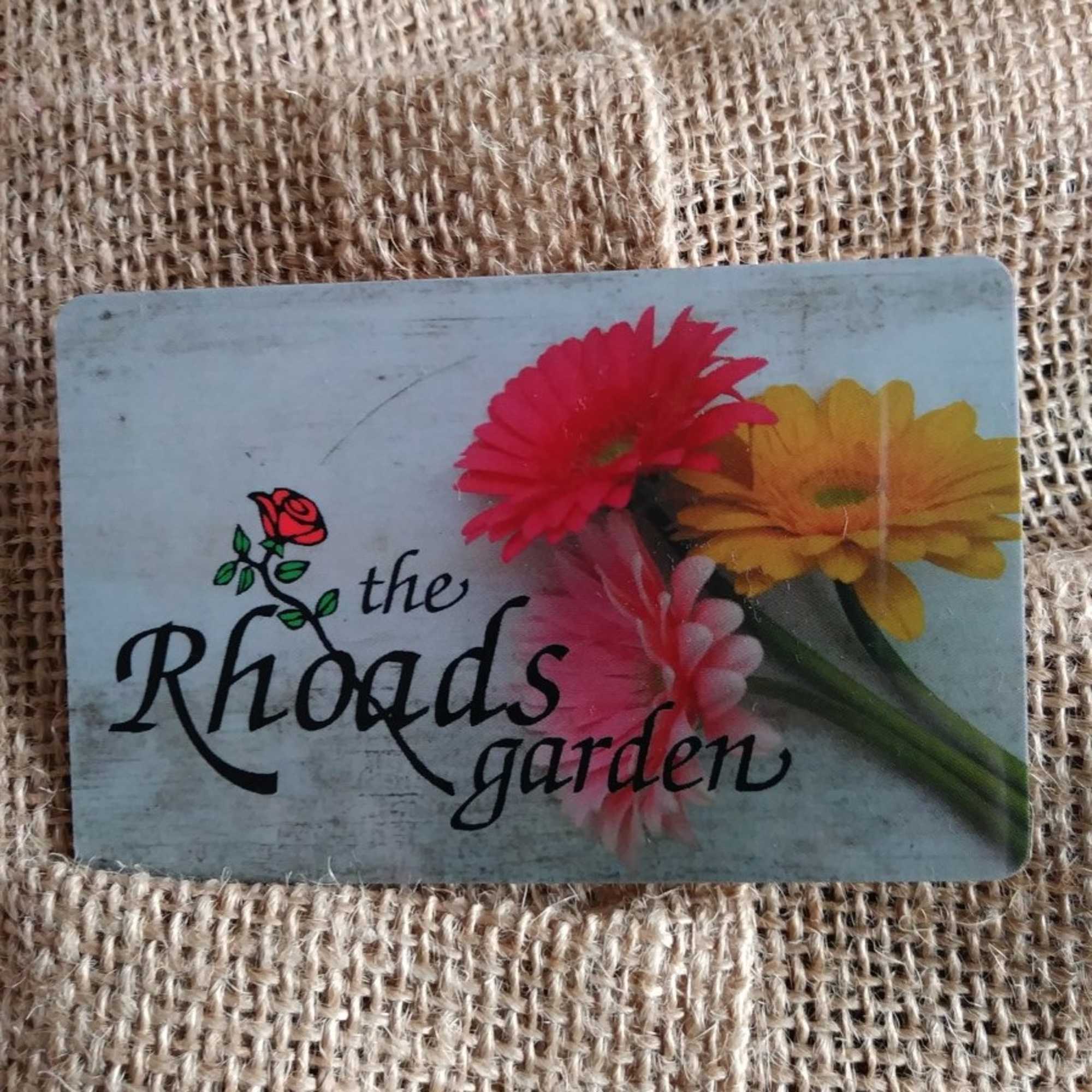 Card with colorful gerbera daisies and the words "the Rhoads garden"