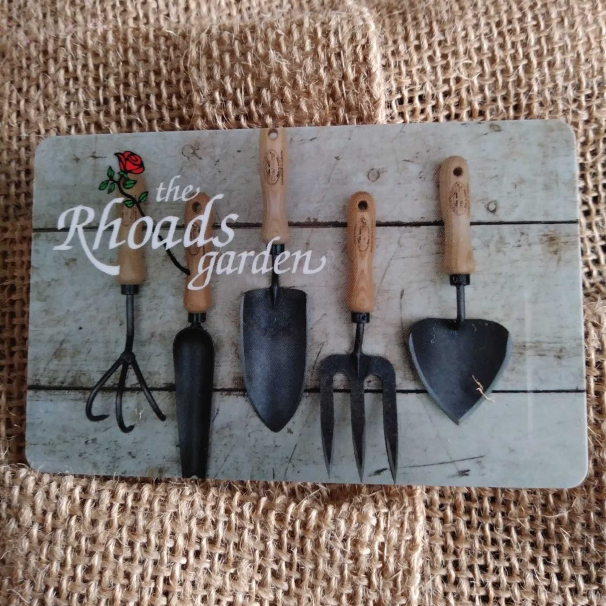 Garden tool set with wooden handles on a printed card