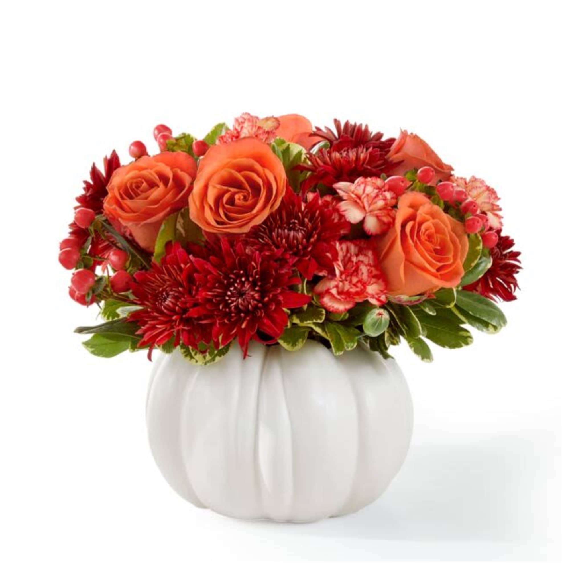 Orange roses and red mums in a white pumpkin vase