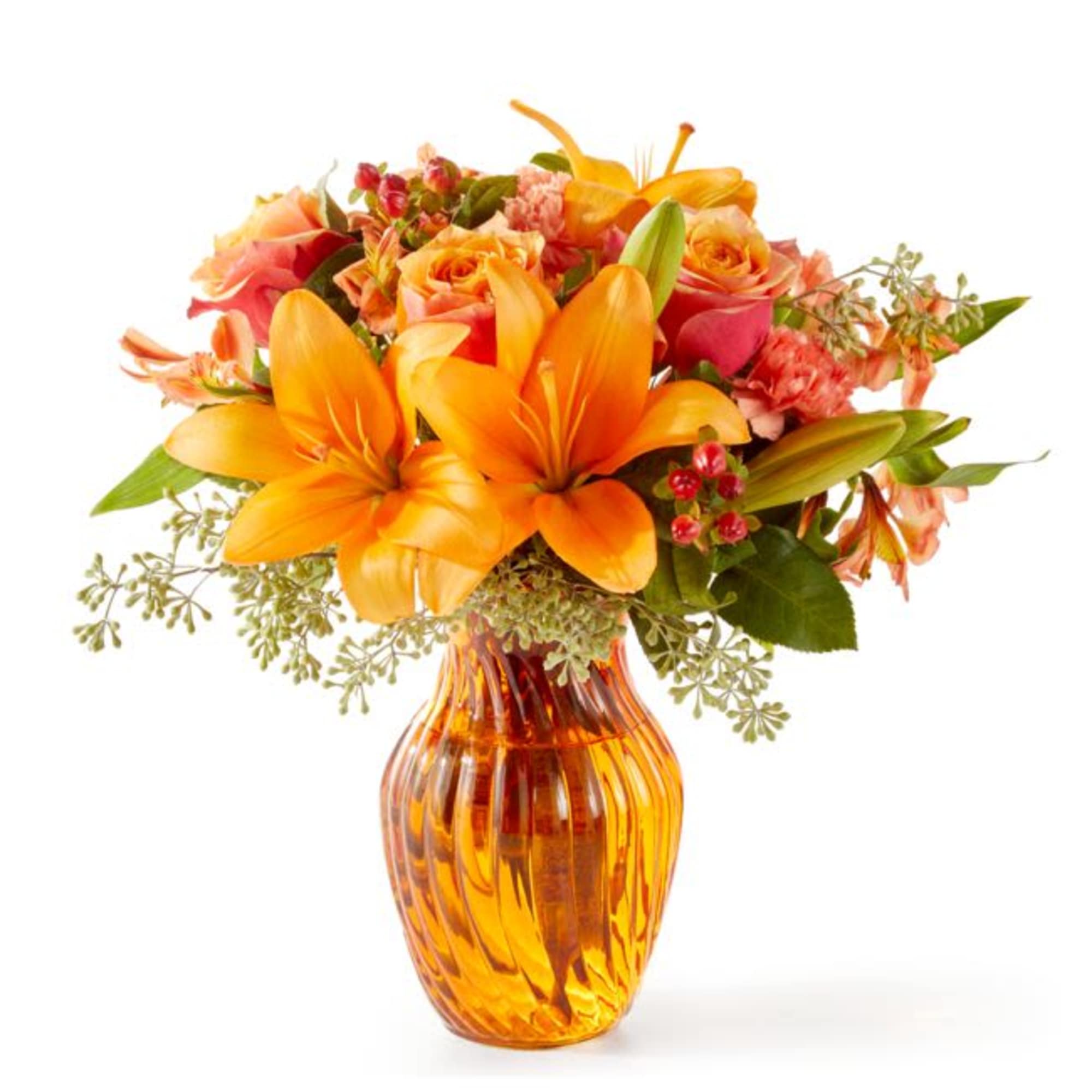 Orange lilies and pink roses in an amber glass vase