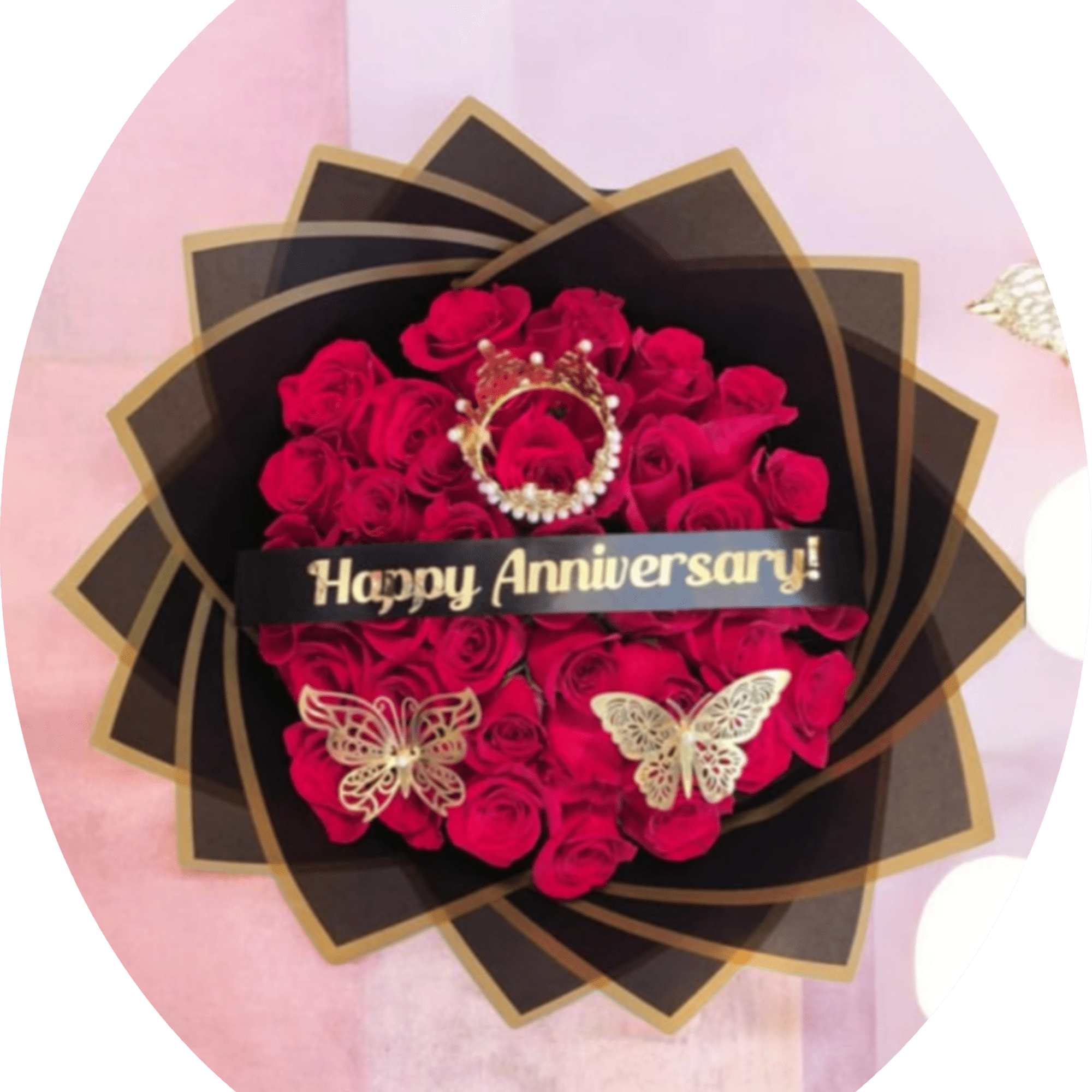 A dense cluster of vivid red roses wrapped in layered black paper