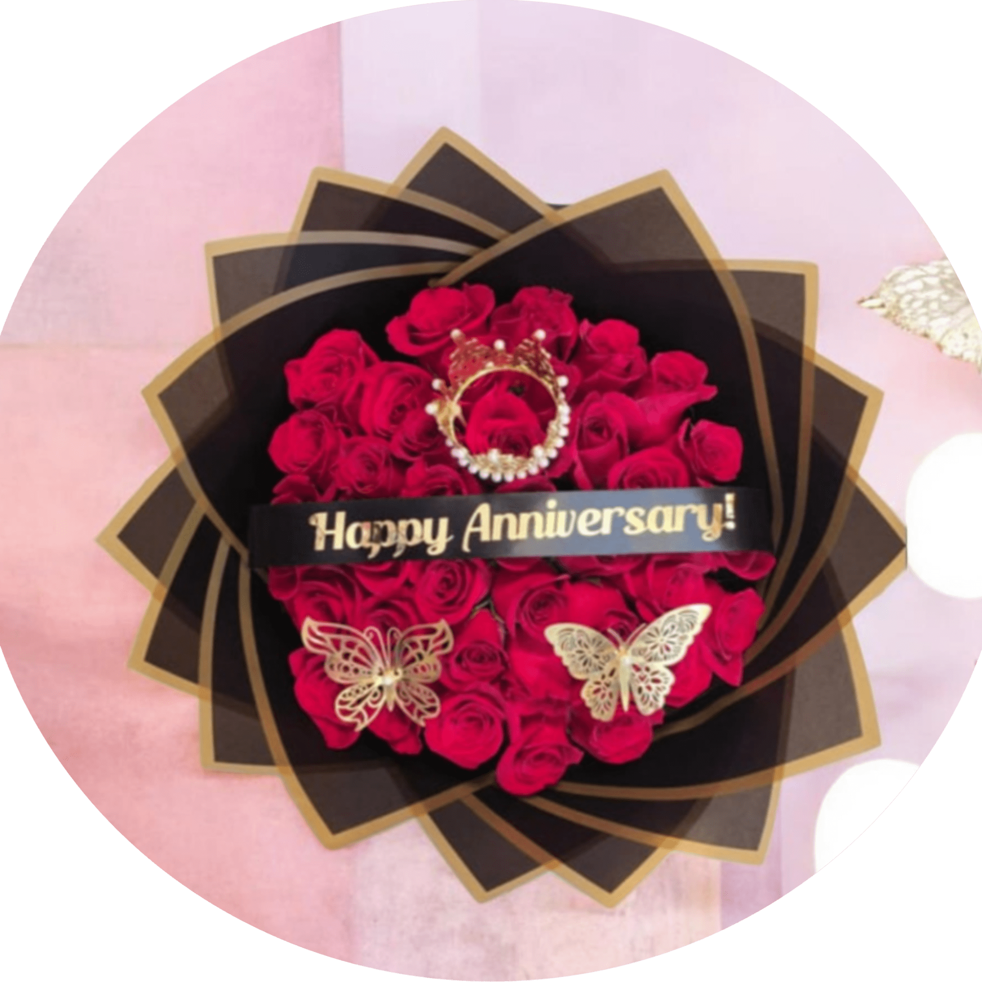 A dense cluster of vivid red roses wrapped in layered black paper