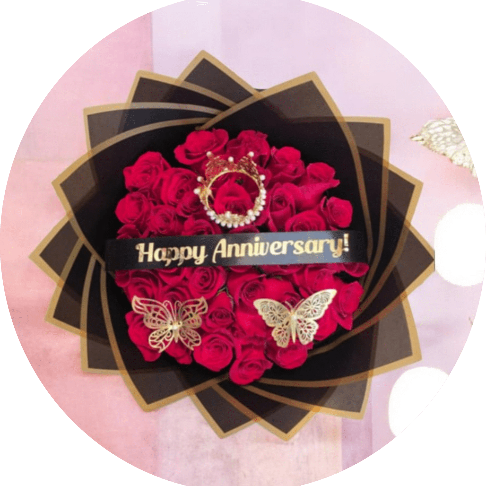 A dense cluster of vivid red roses wrapped in layered black paper