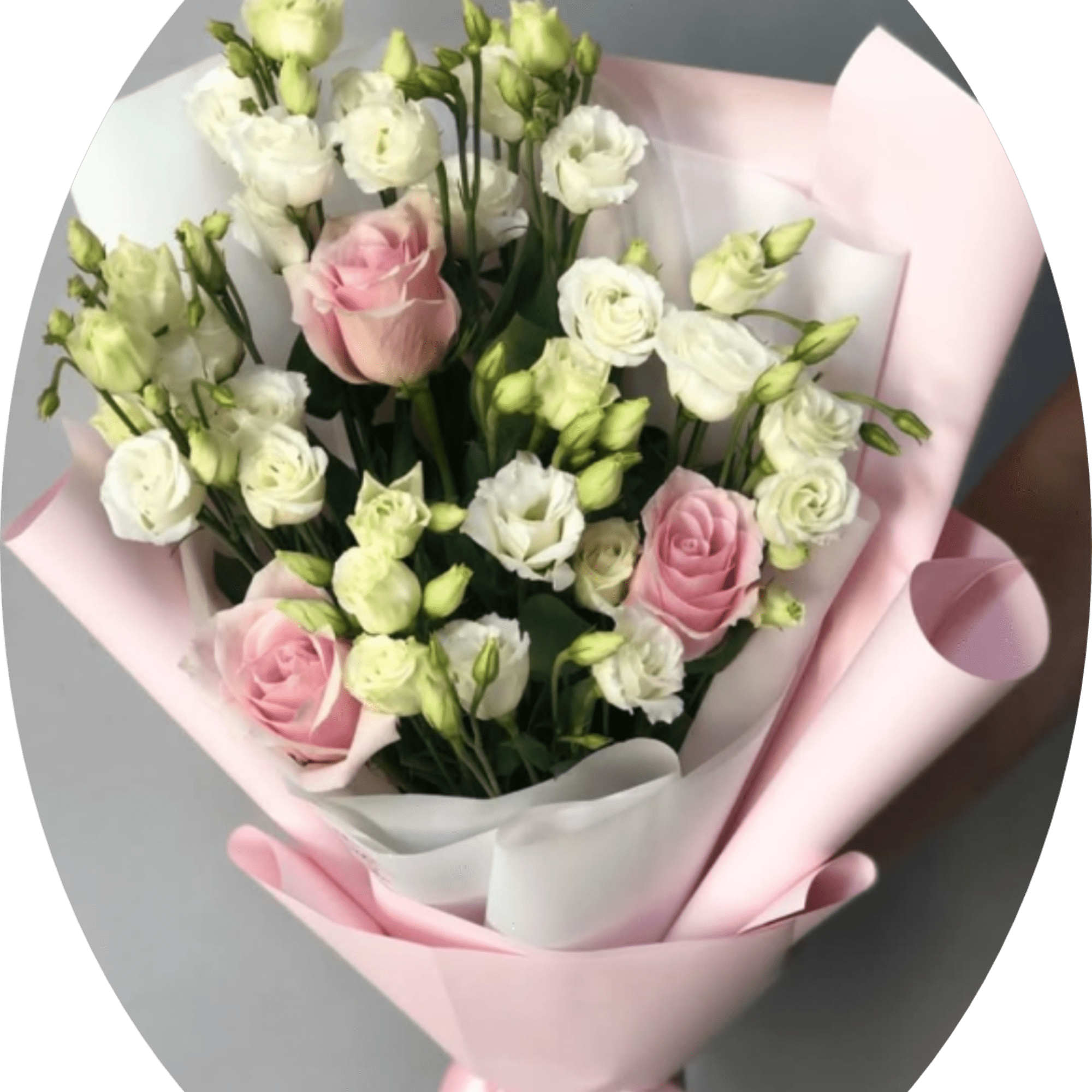 Soft pink roses paired with clusters of white lisianthus create a gently