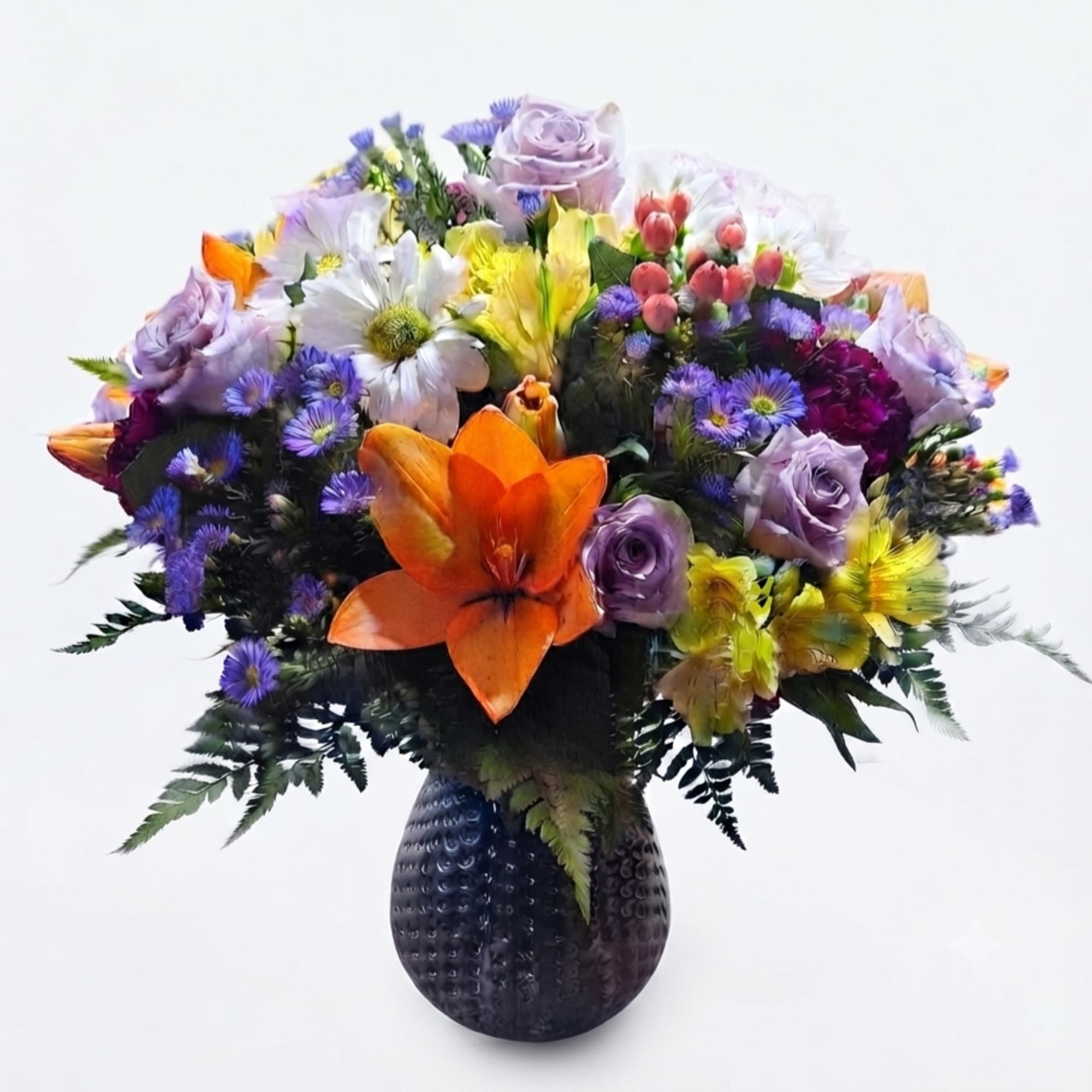 Mixed bouquet of colorful flowers in a dark textured vase