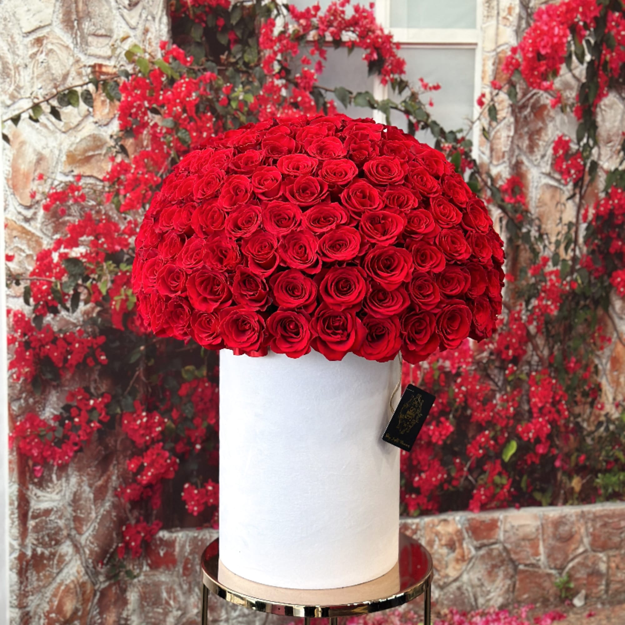 Large dome of red roses in a white cylindrical box