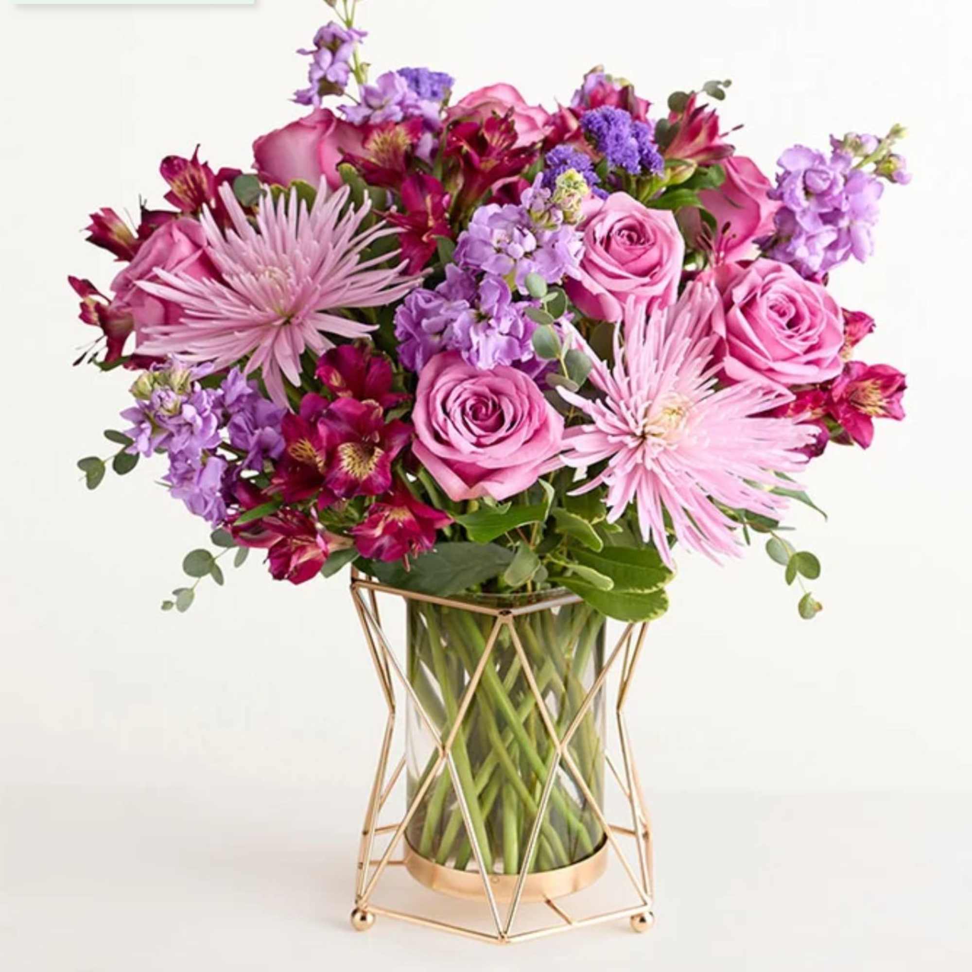 Pink and purple mixed flower bouquet in a glass vase