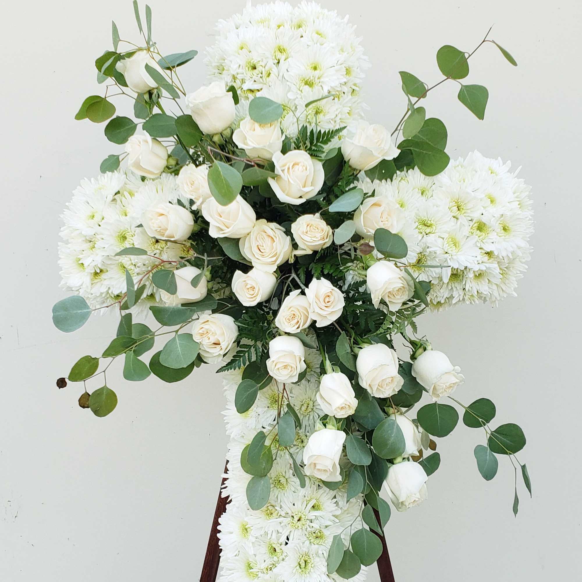 White rose and chrysanthemum standing spray on an easel