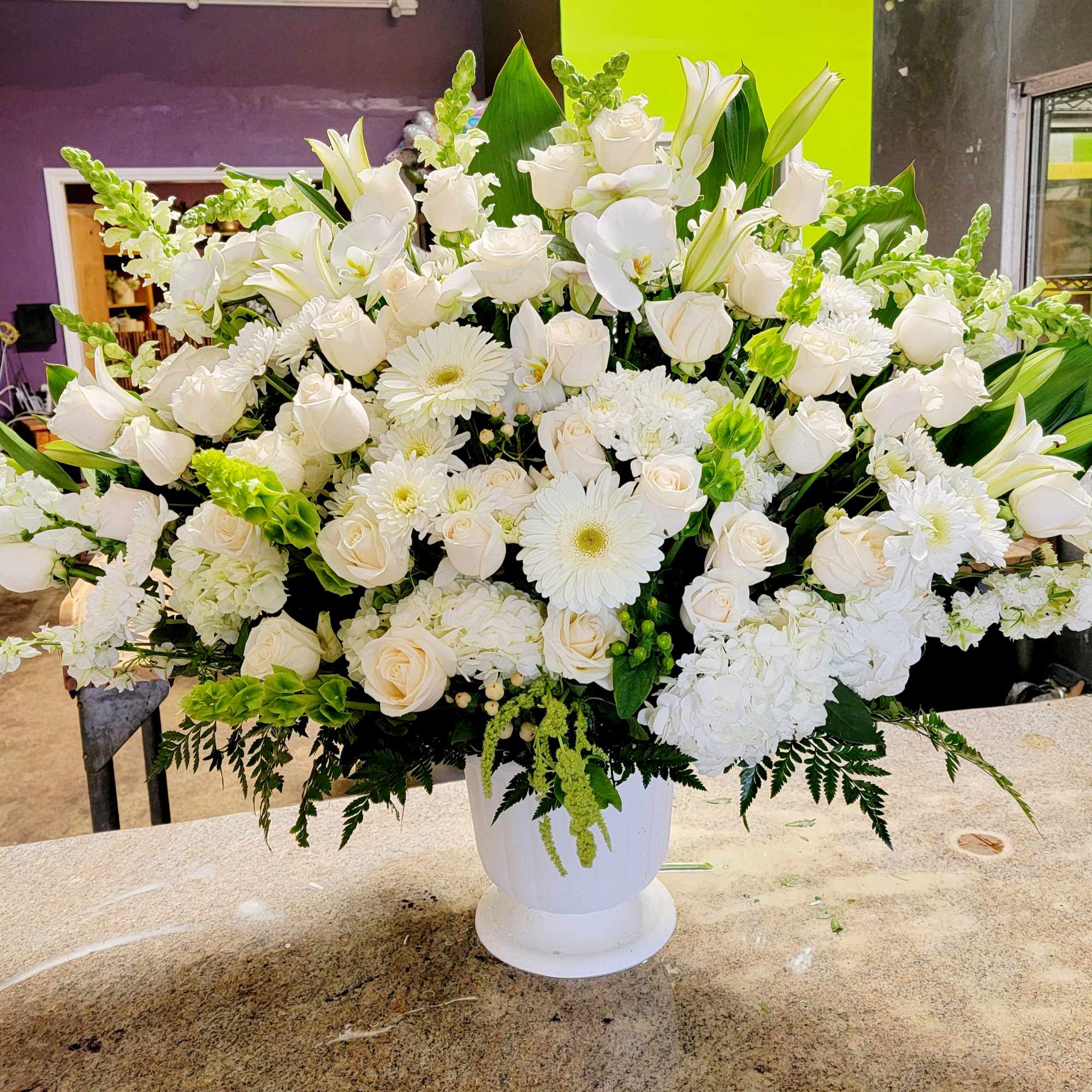 Large white floral arrangement in a white pedestal vase, photo 3 of 3