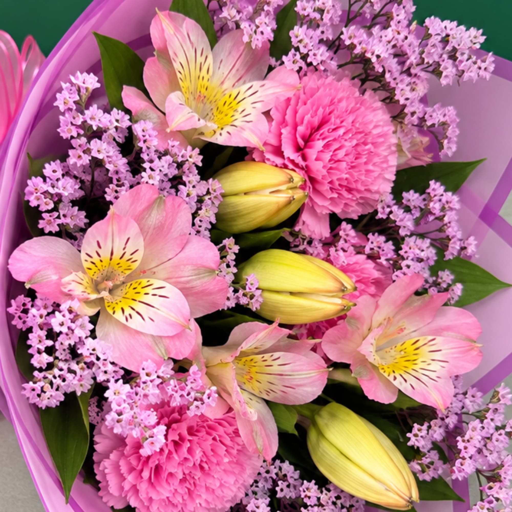 Pink and lavender bouquet with lilies, carnations, and small filler flowers