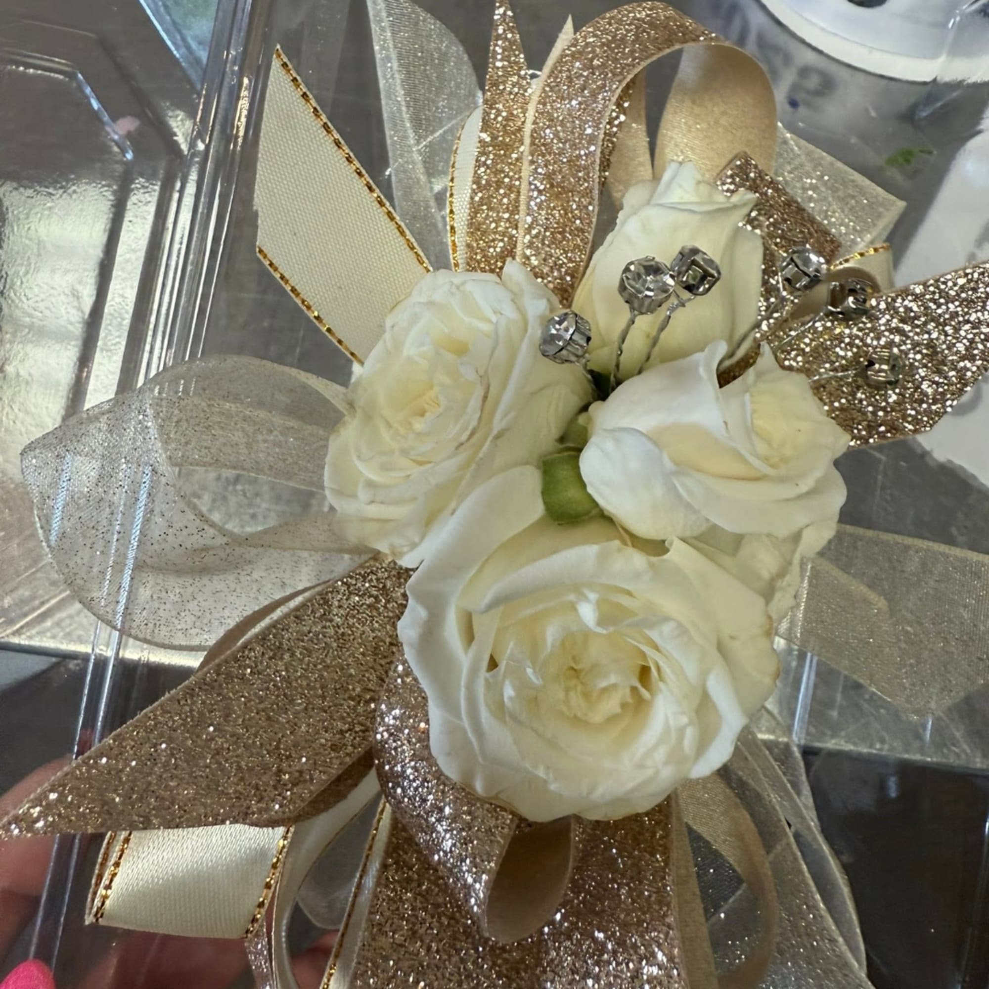 White rose bouquet with gold and silver ribbon accents