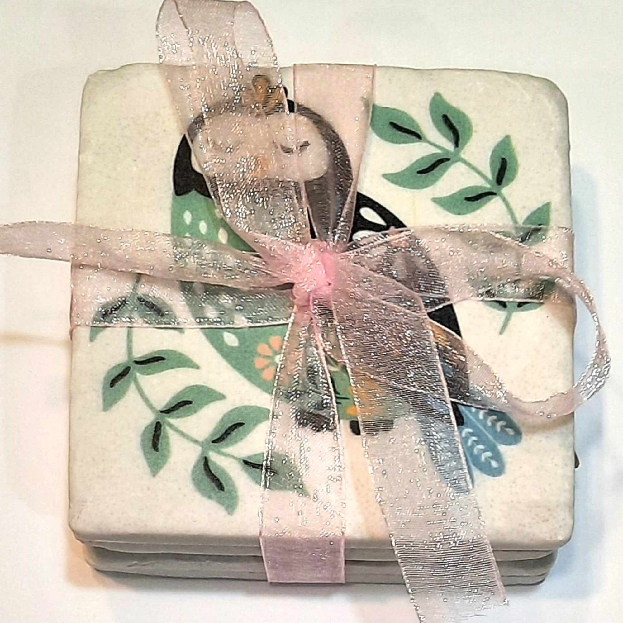 Stack of floral-patterned coasters tied with a pink ribbon