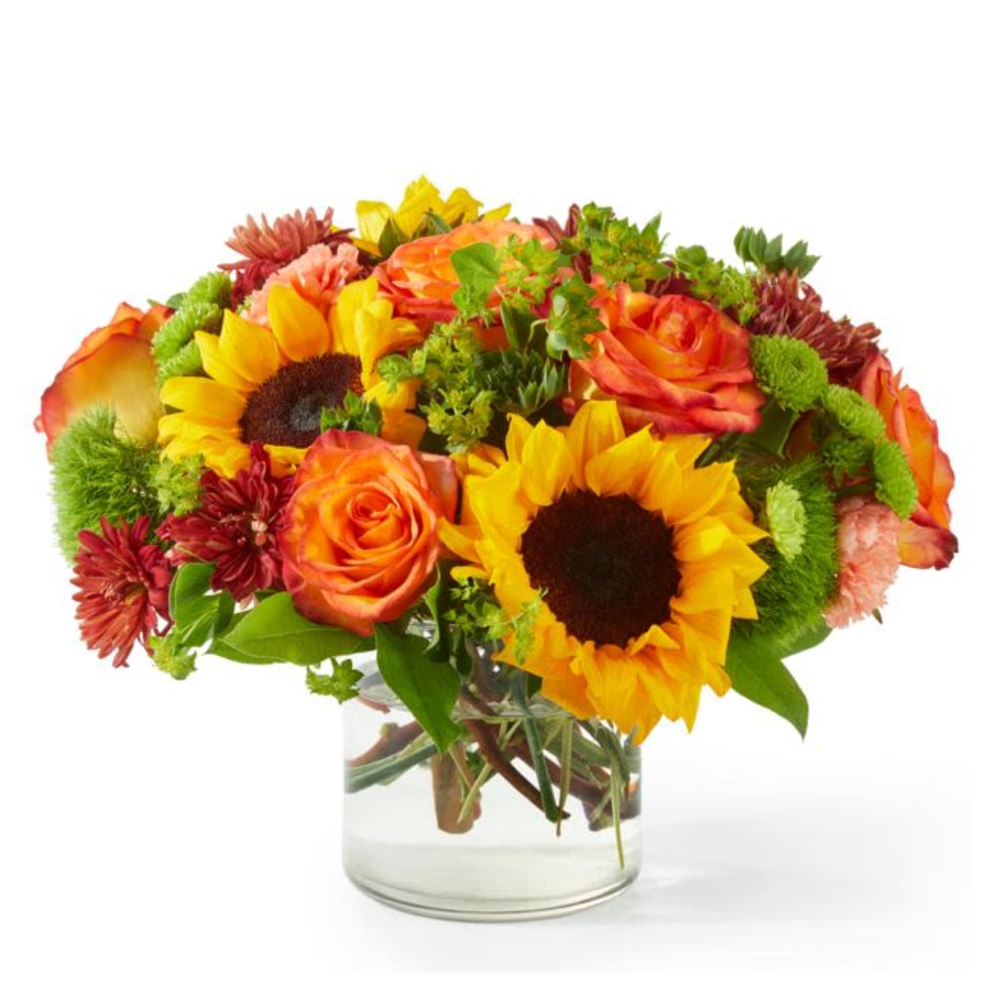 Bouquet of sunflowers, orange roses, and mixed mums in a clear glass vase