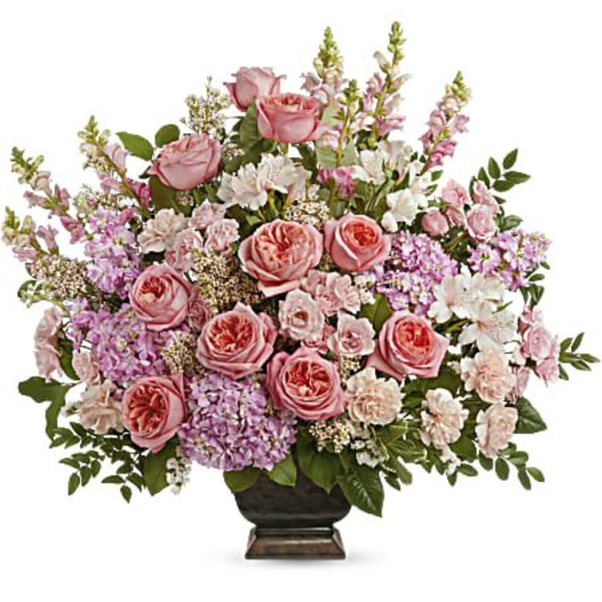 Pink roses and mixed pastel flowers arranged in a dark vase