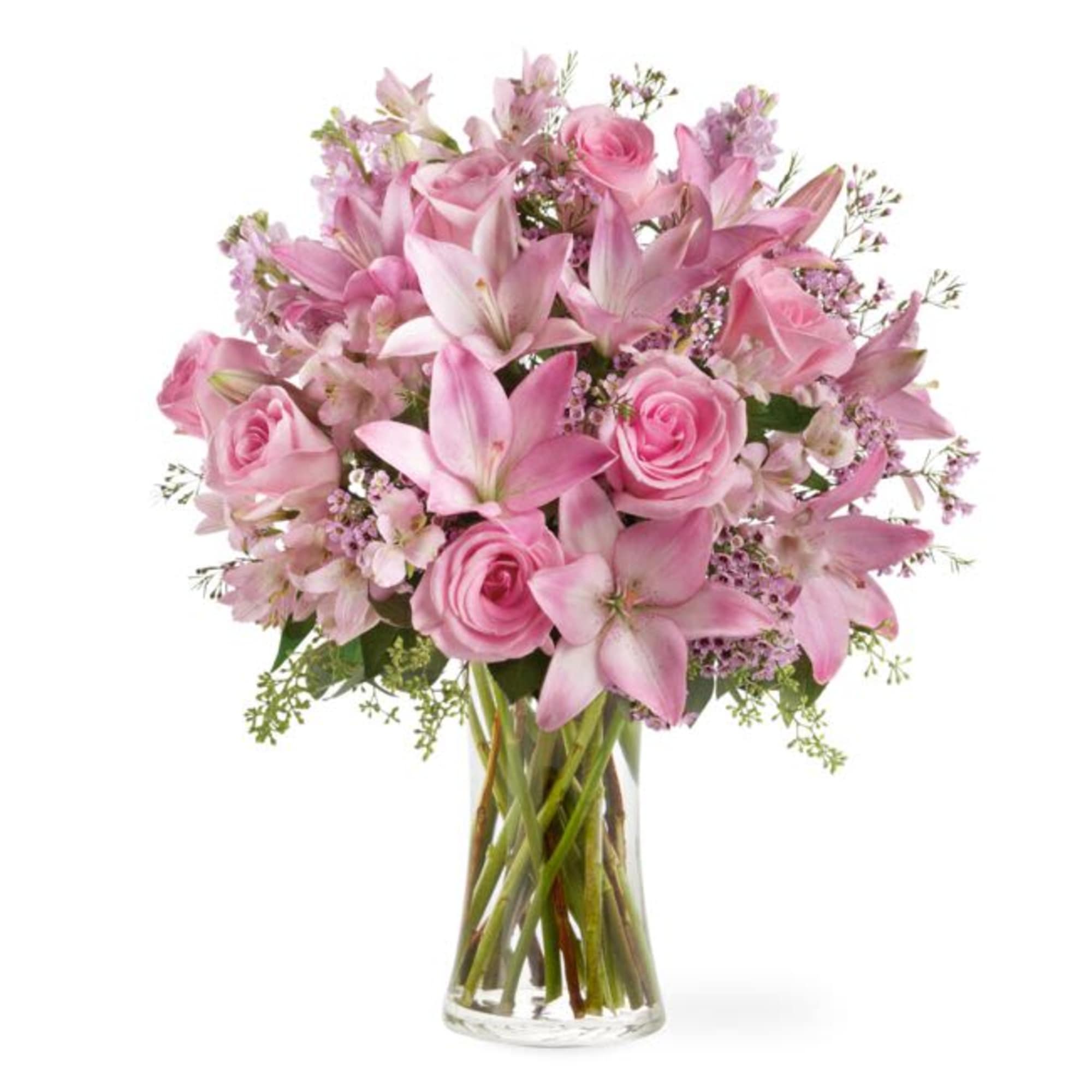 Pink roses and lilies arranged in a clear glass vase