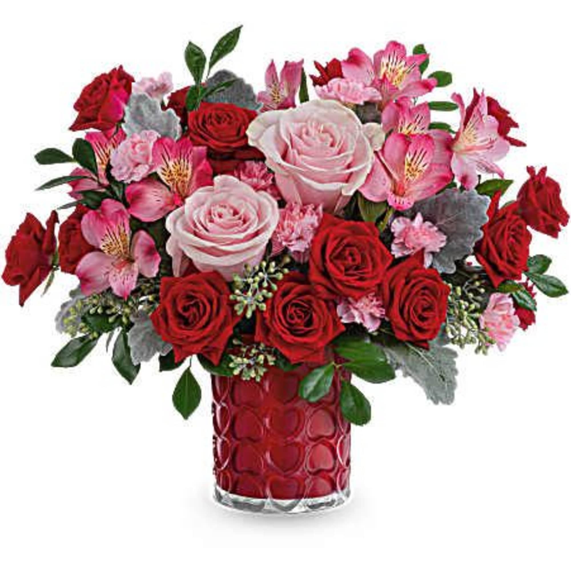 Red and pink rose bouquet in a red glass vase