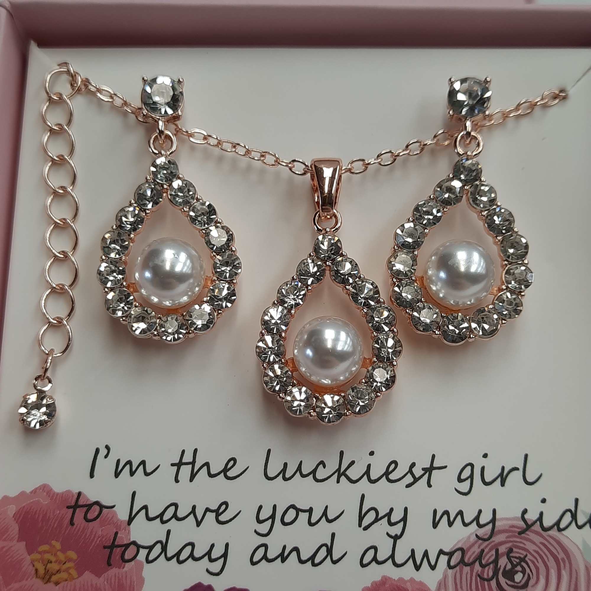 Jeweled pearl necklace set in a gift box with a printed message card