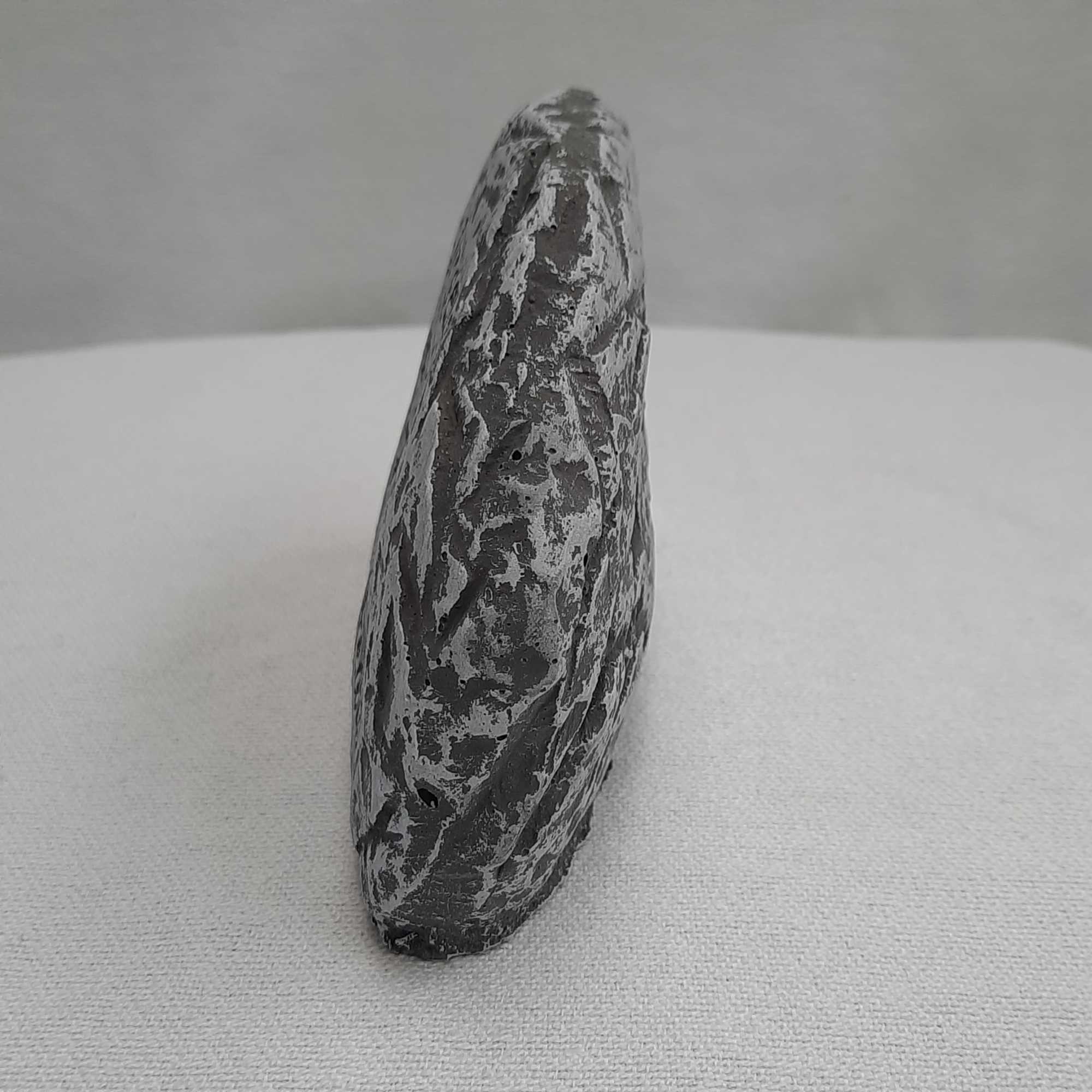 A single mottled gray-and-black stone standing upright
