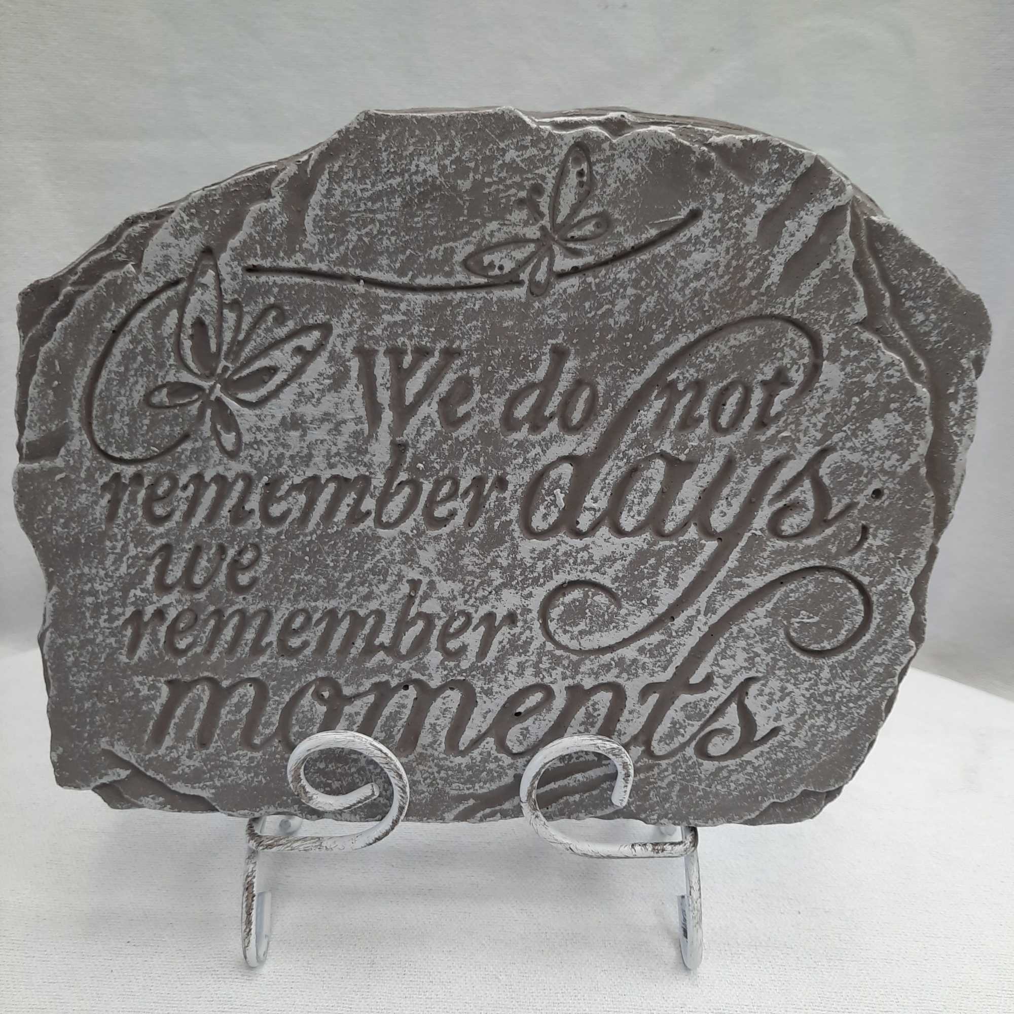 Gray memorial plaque on a metal stand with butterfly accents