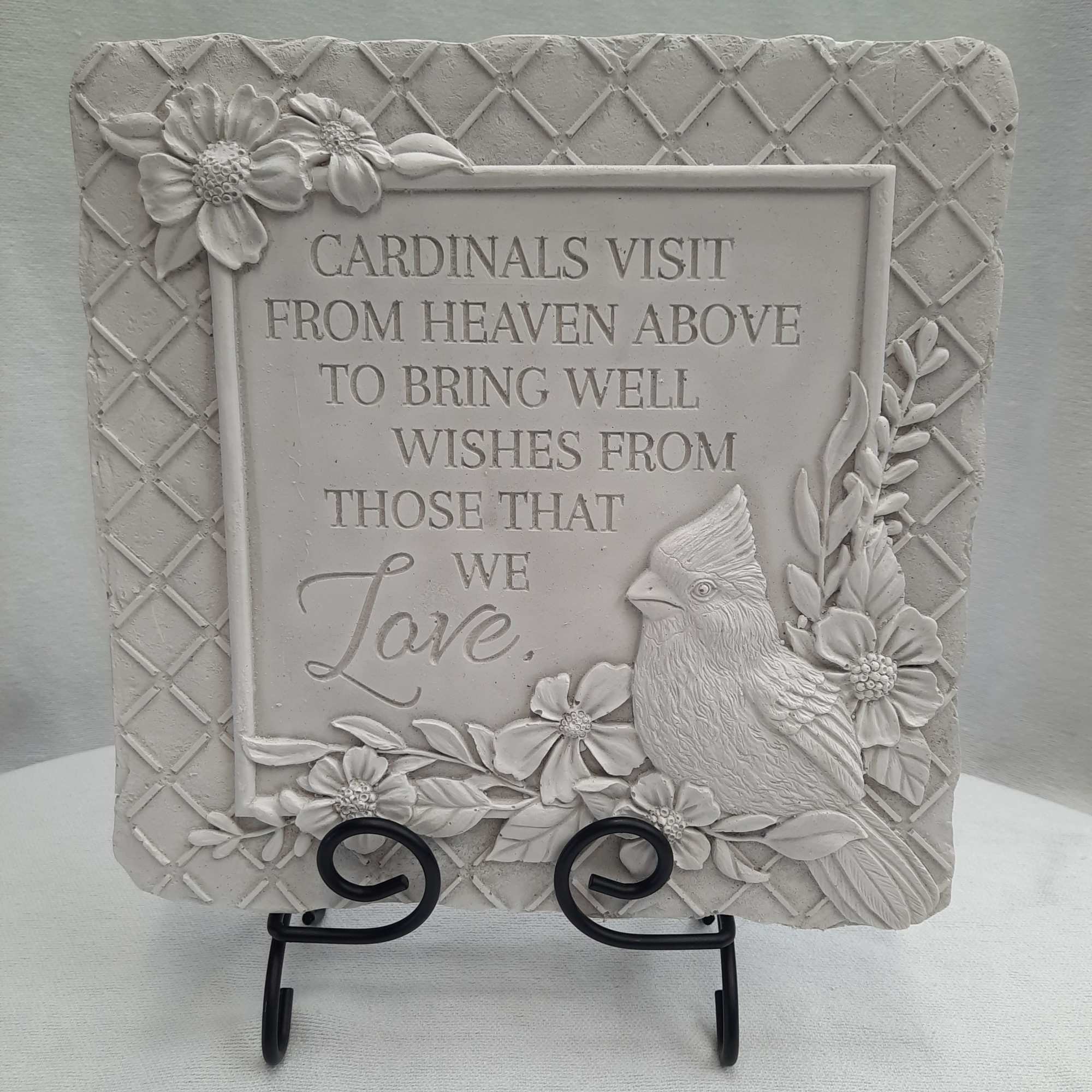 Decorative plaque with a cardinal and floral relief around a sympathy message