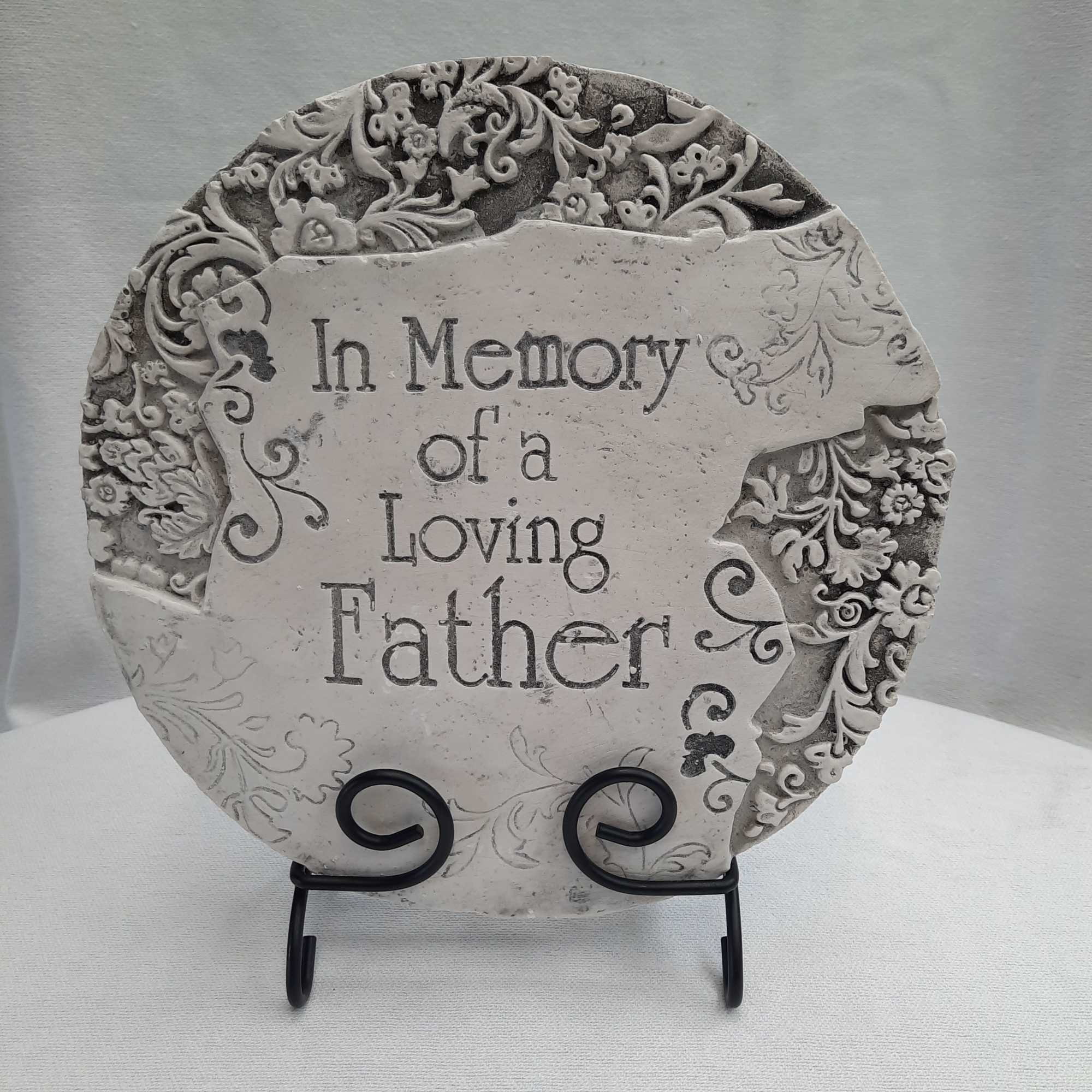 Decorative memorial plaque reading "In Memory of a Loving Father" on a stand