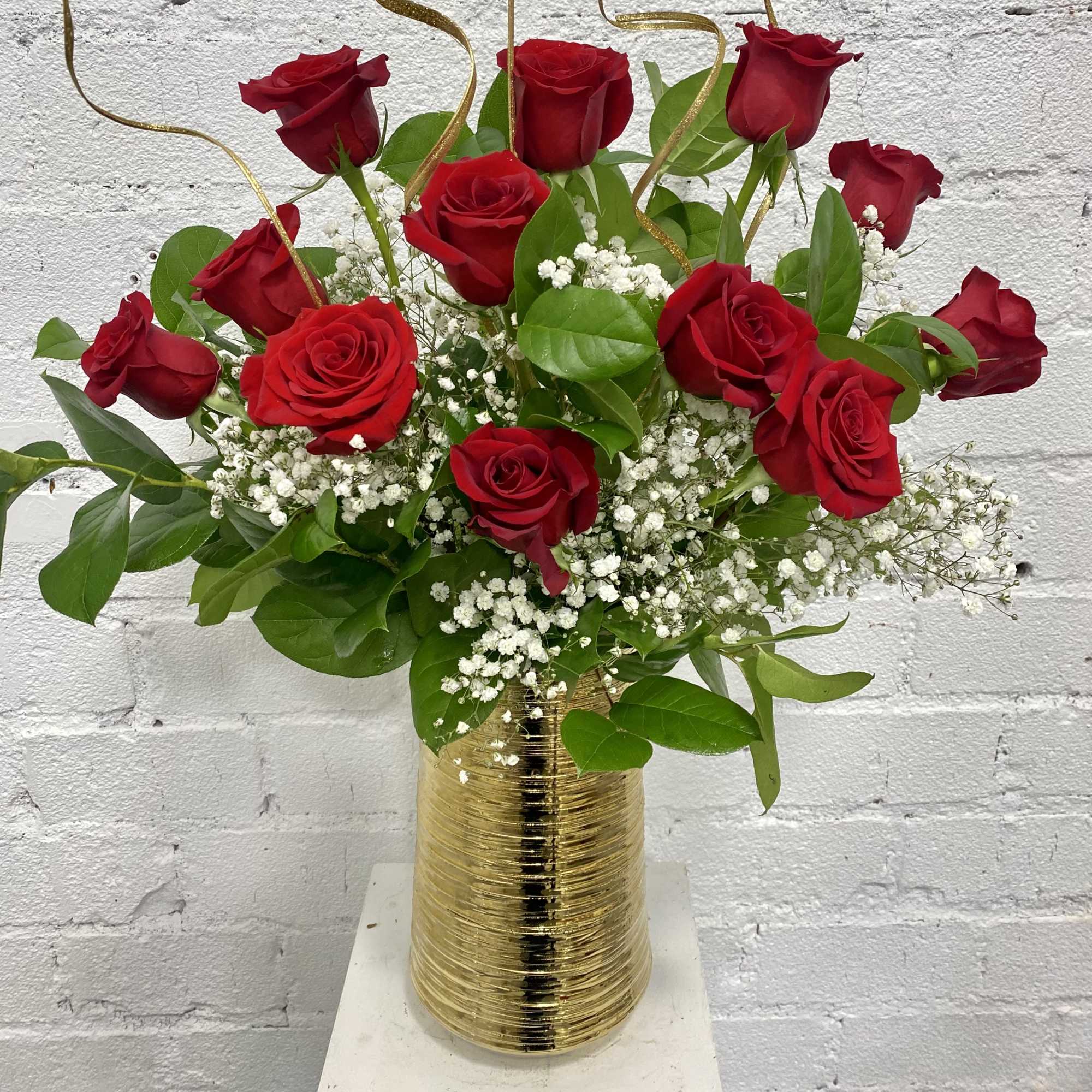 Red roses arranged in a gold vase with white baby's breath, photo 3 of 4