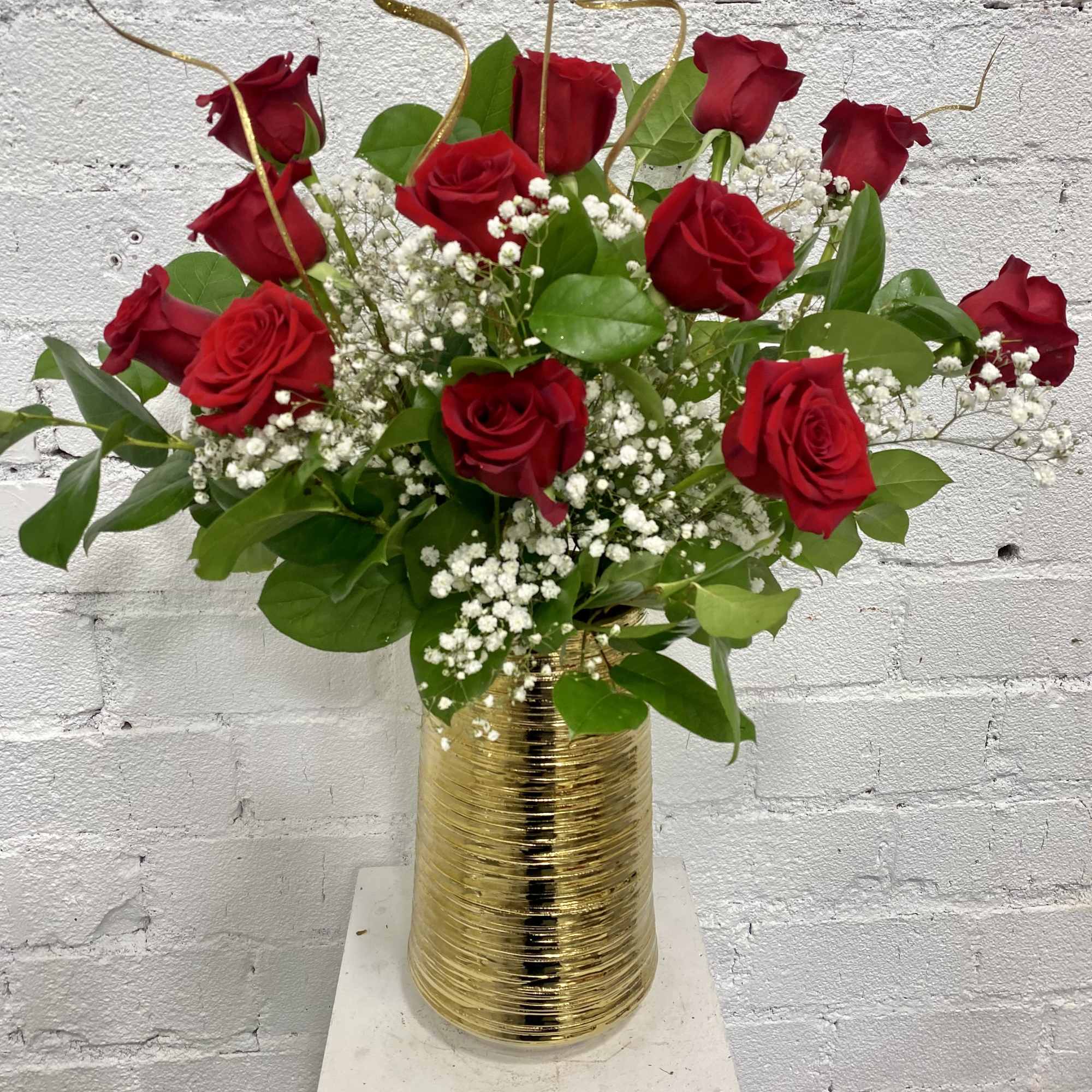 Red roses arranged in a gold vase with white baby's breath, photo 4 of 4
