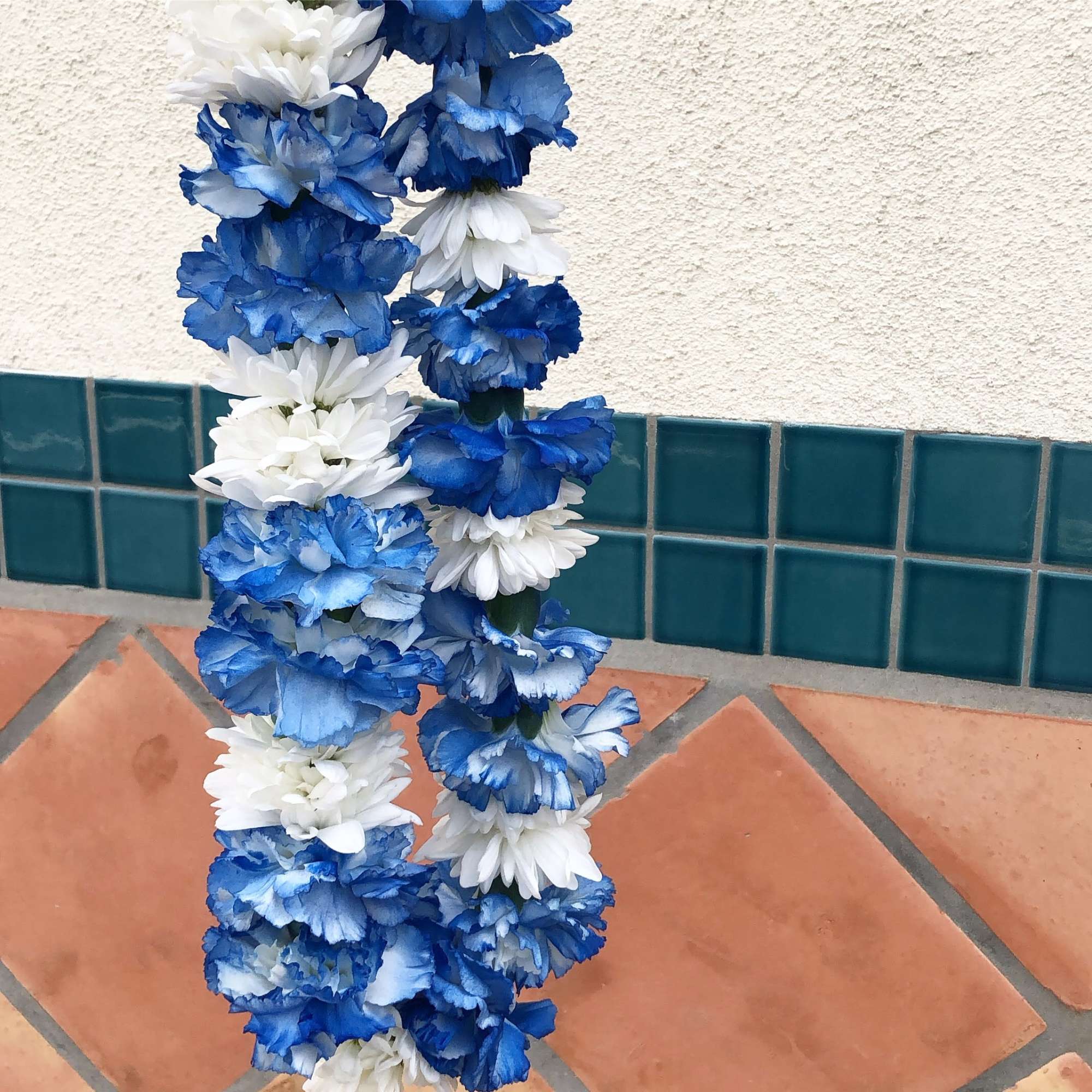 Blue and white flower garlands hanging vertically
