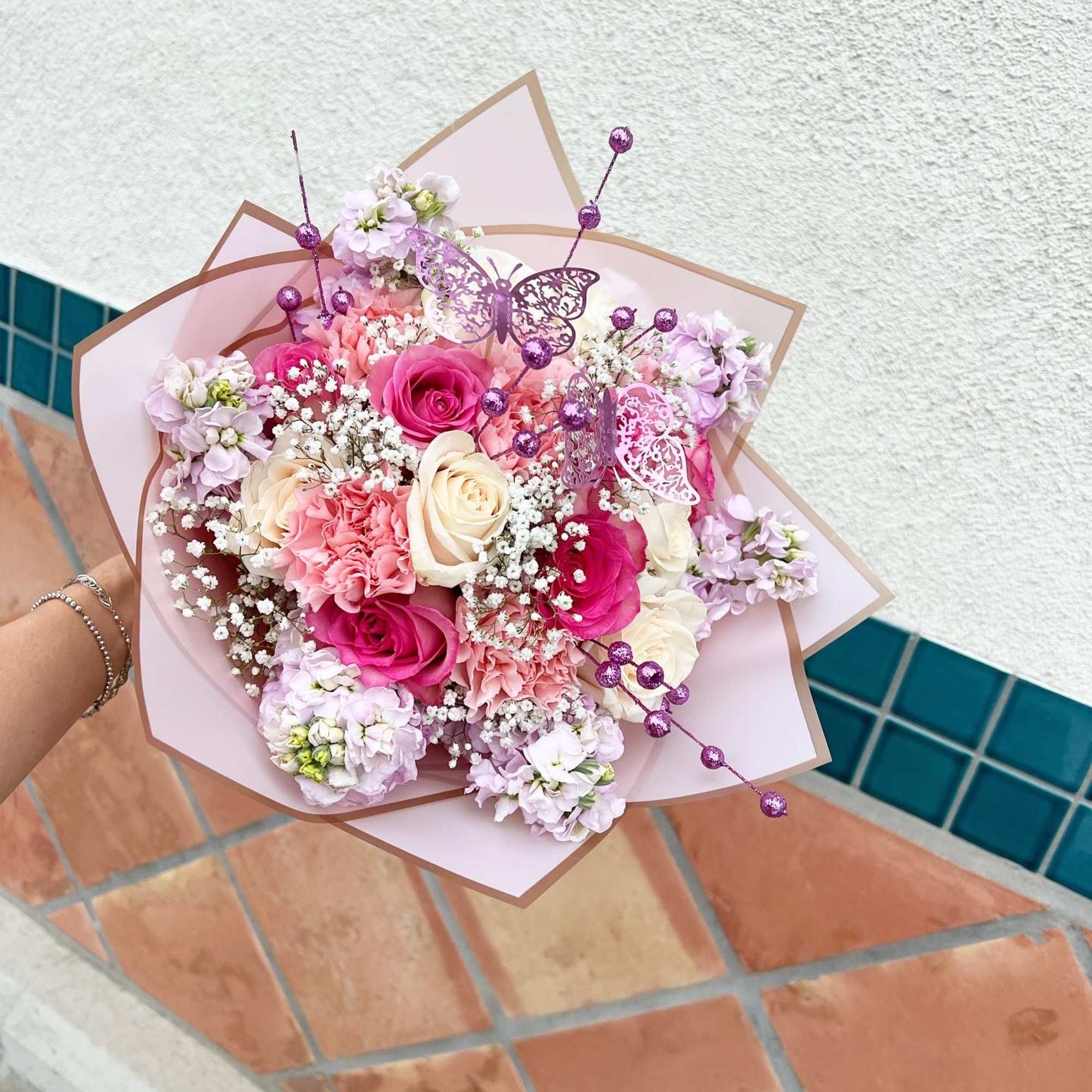 Pink and white bouquet with roses, carnations, and lilac flowers