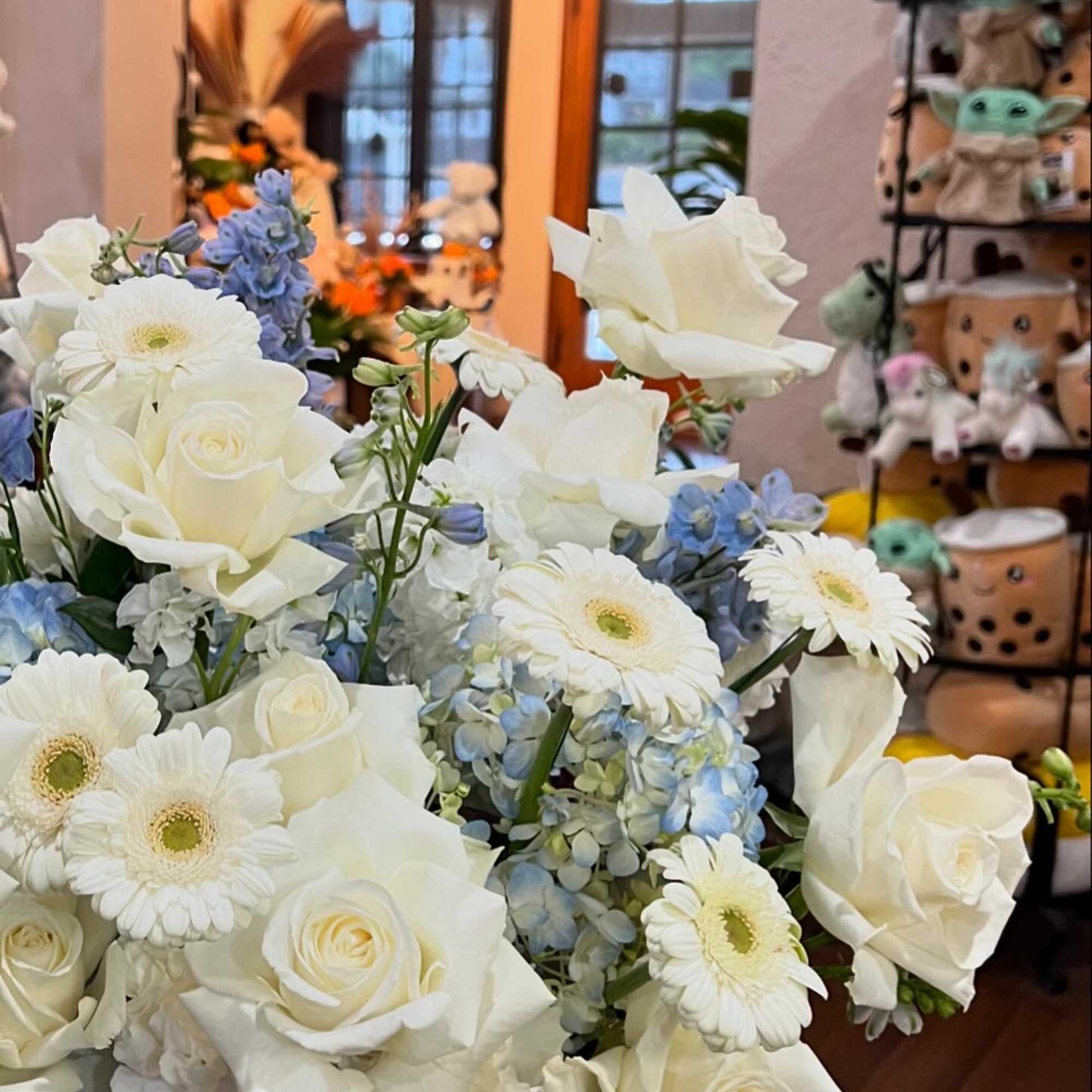 Bouquet of white roses, white gerbera daisies, and blue hydrangeas
