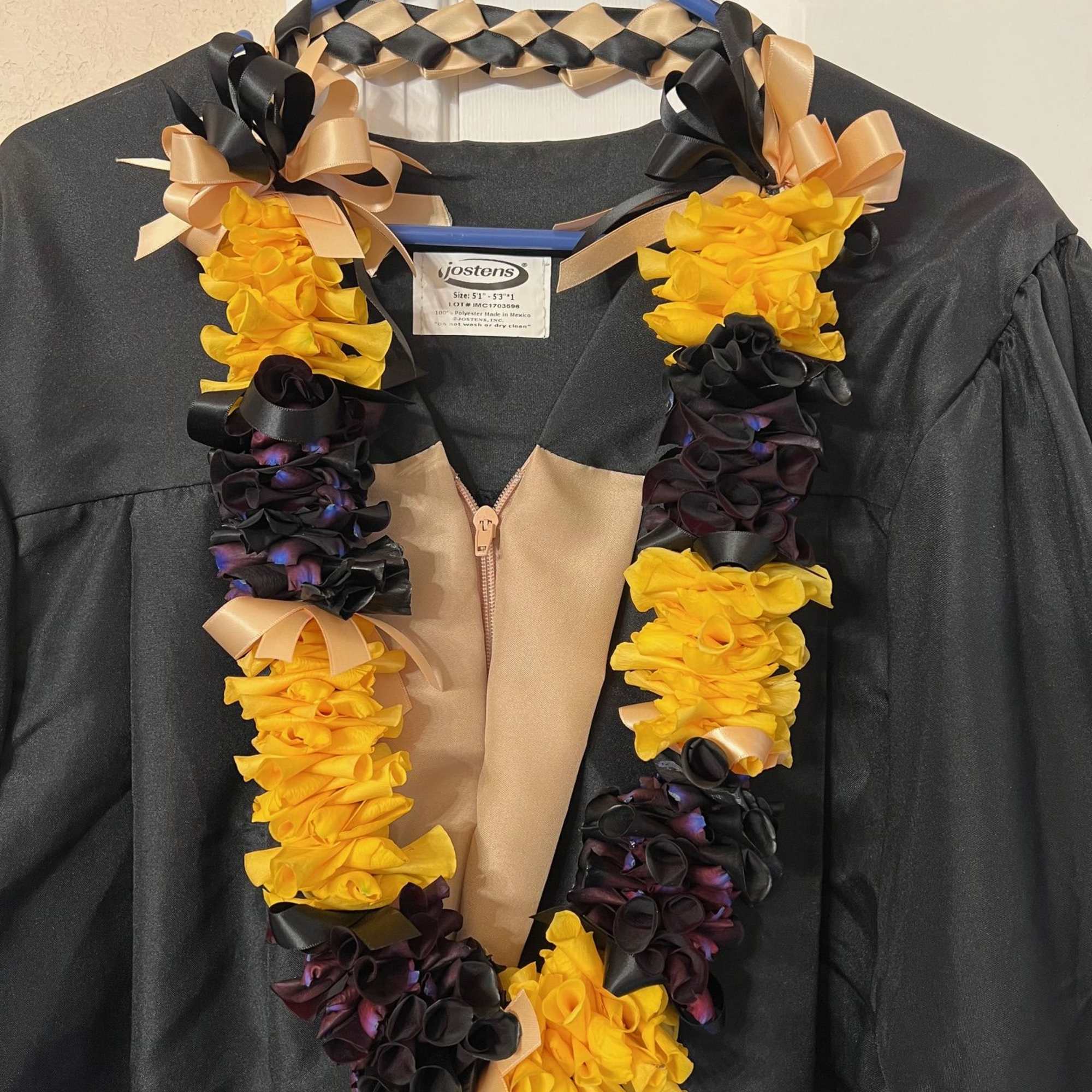 Black and yellow rose petals lei with black and gold ribbons