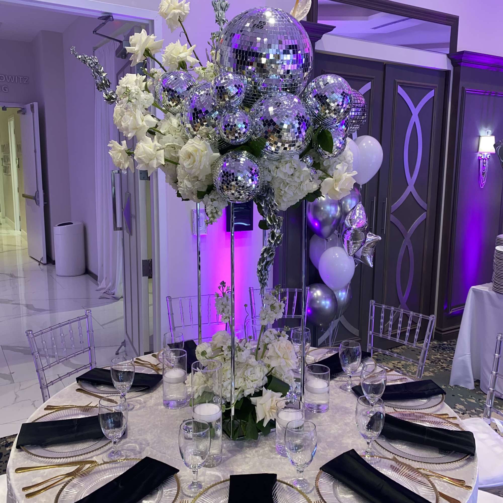 Decoration with variety of white flowers and disco balls. Arrangements of different