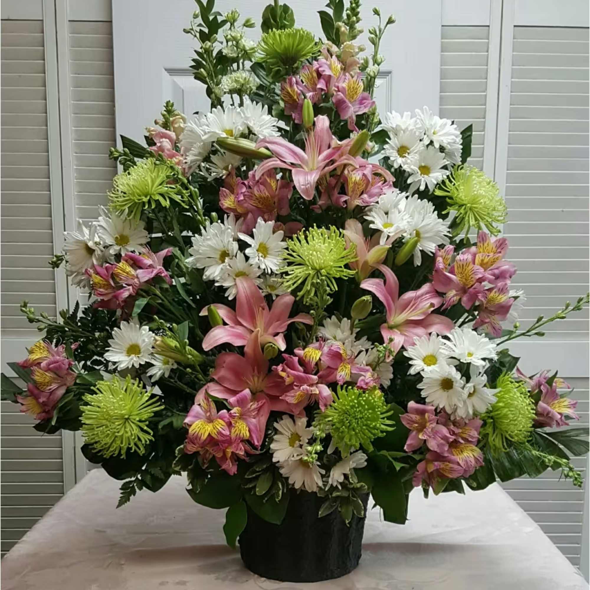 This Traditional Funeral Spray with Spring Colors consists of Pink Lilies, Snapdragons