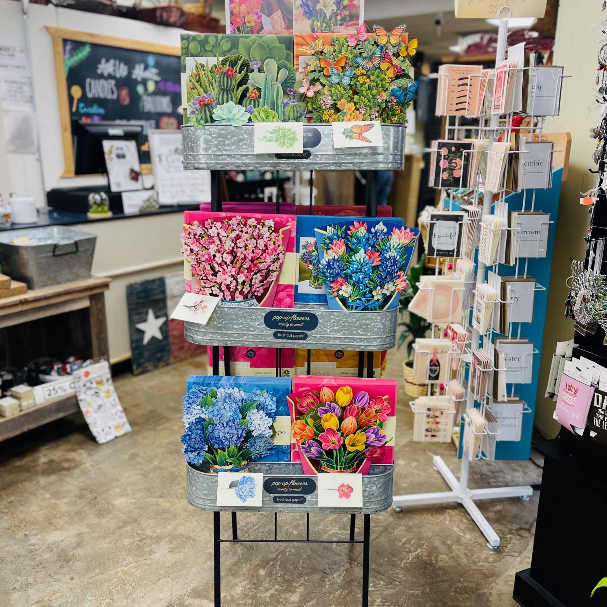 Display rack of colorful pop-up flower cards in a shop, photo 4 of 4