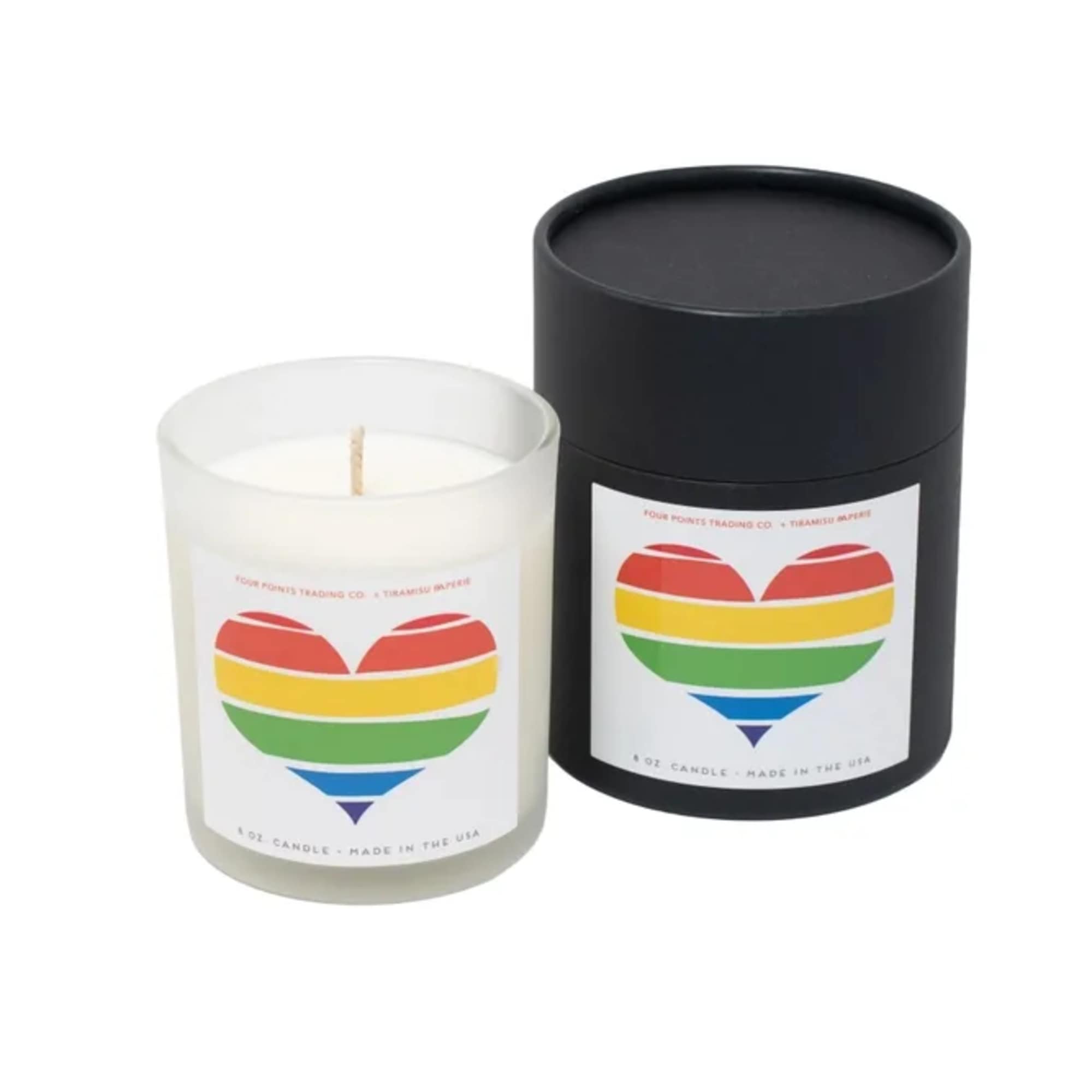 Two candles in cylindrical containers, one clear and one black, with rainbow heart labels