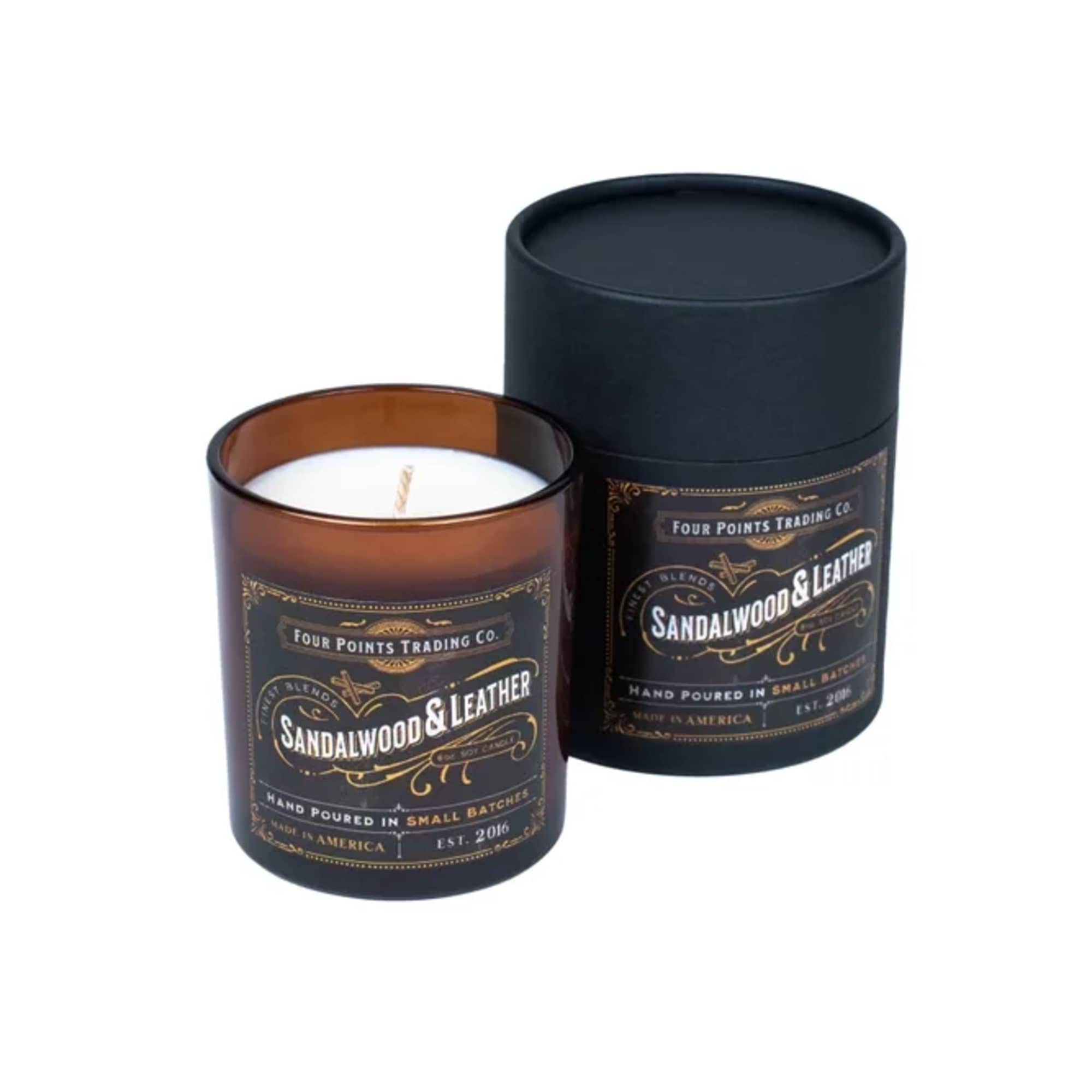 Two sandalwood and leather candles in dark glass jars with a black lid