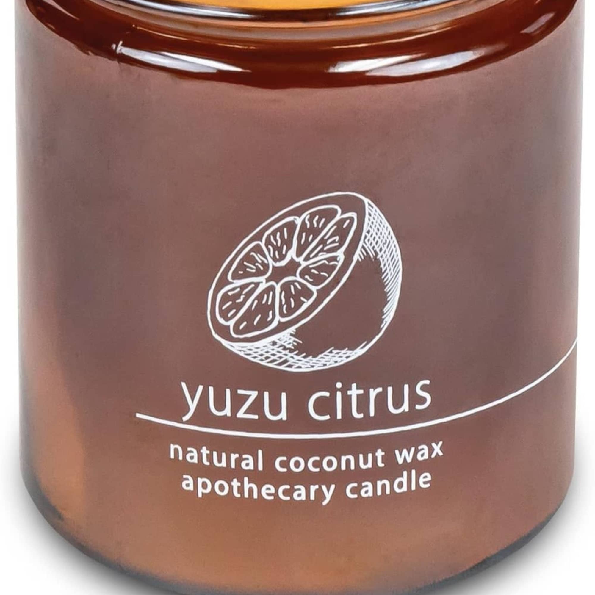 Amber glass candle jar labeled yuzu citrus