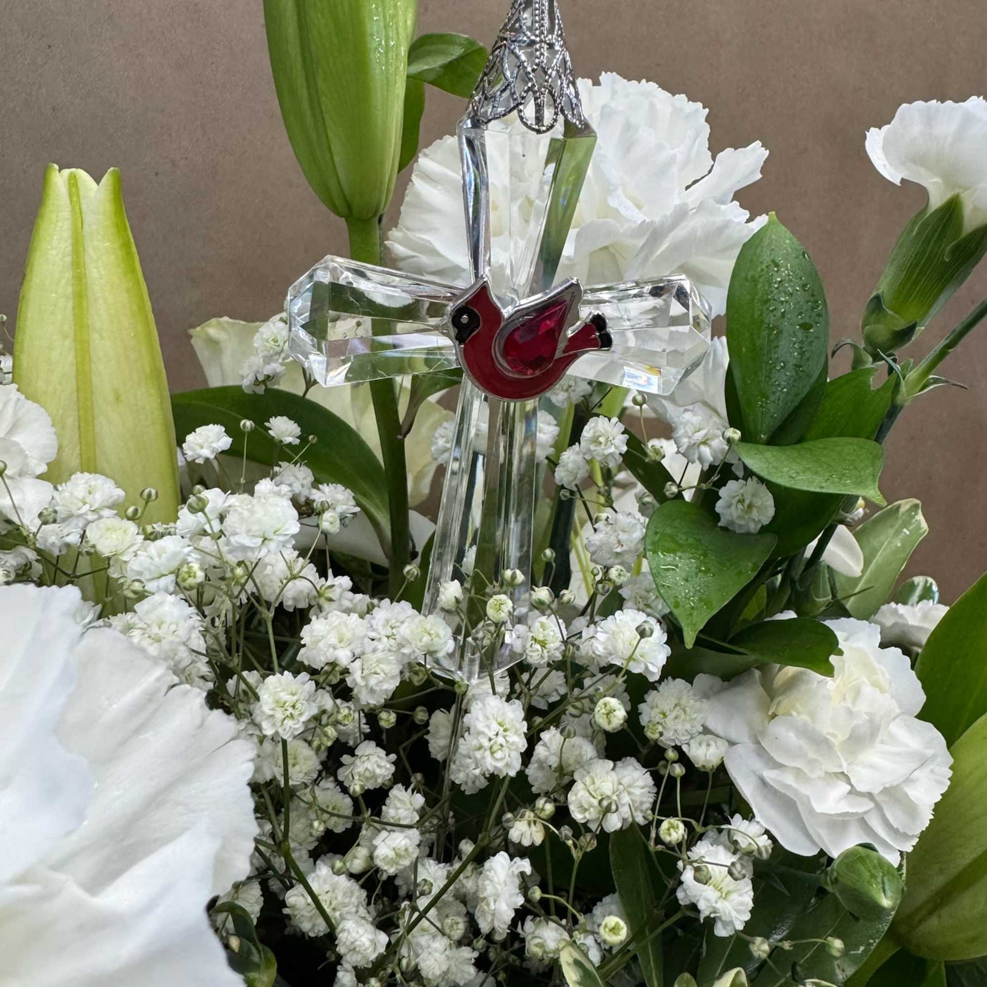 White floral arrangement with a crystal cross centerpiece